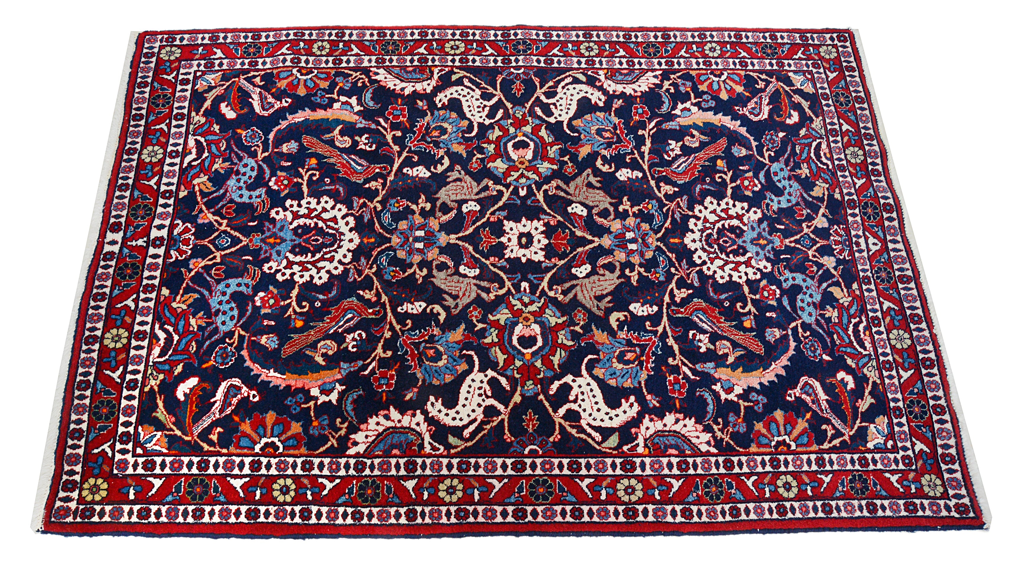 Hand-knotted vintage Mashhad rug with dark blue field and traditional floral pattern