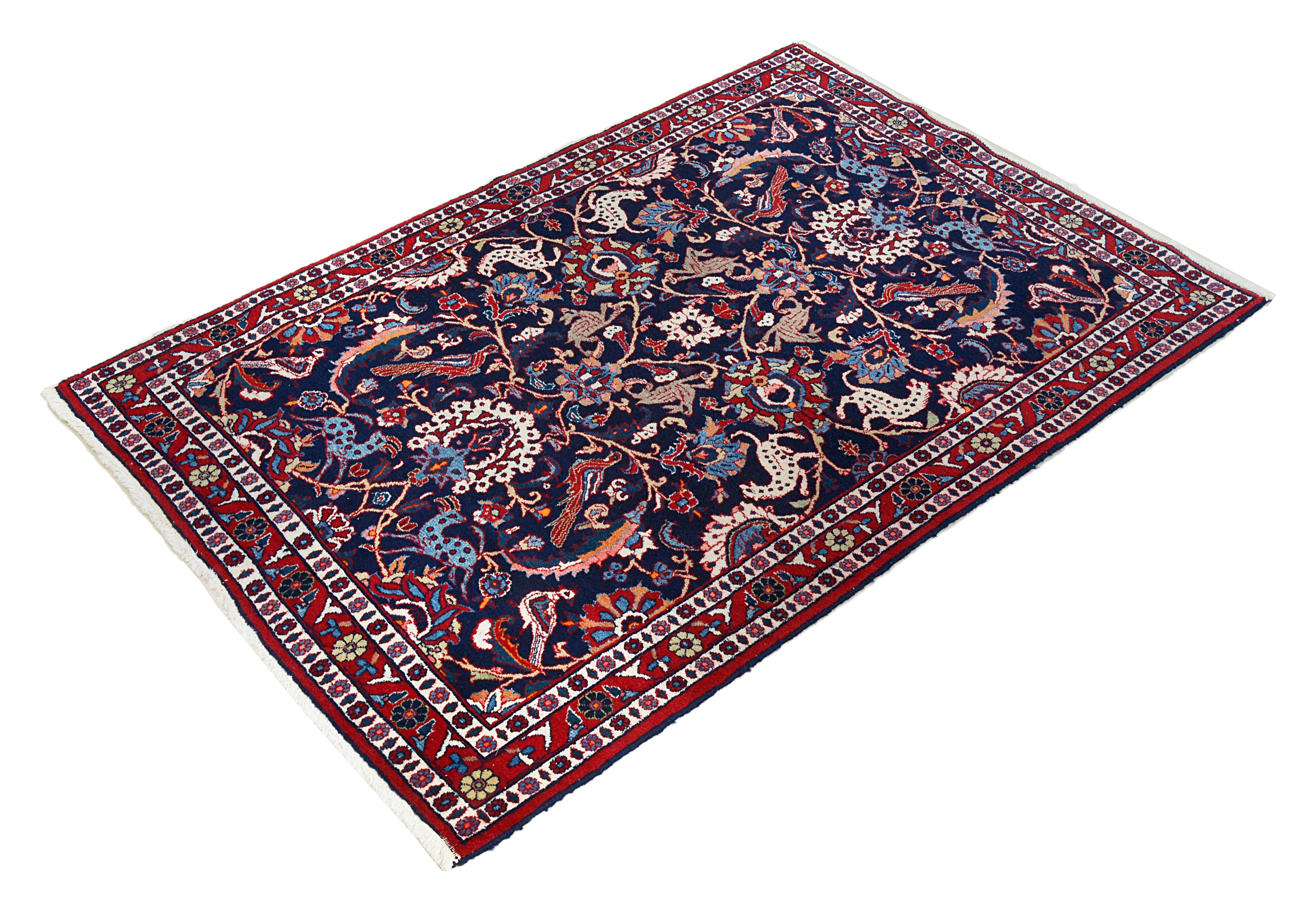 Small vintage Persian Mashhad rug featuring rich colours and classic border design