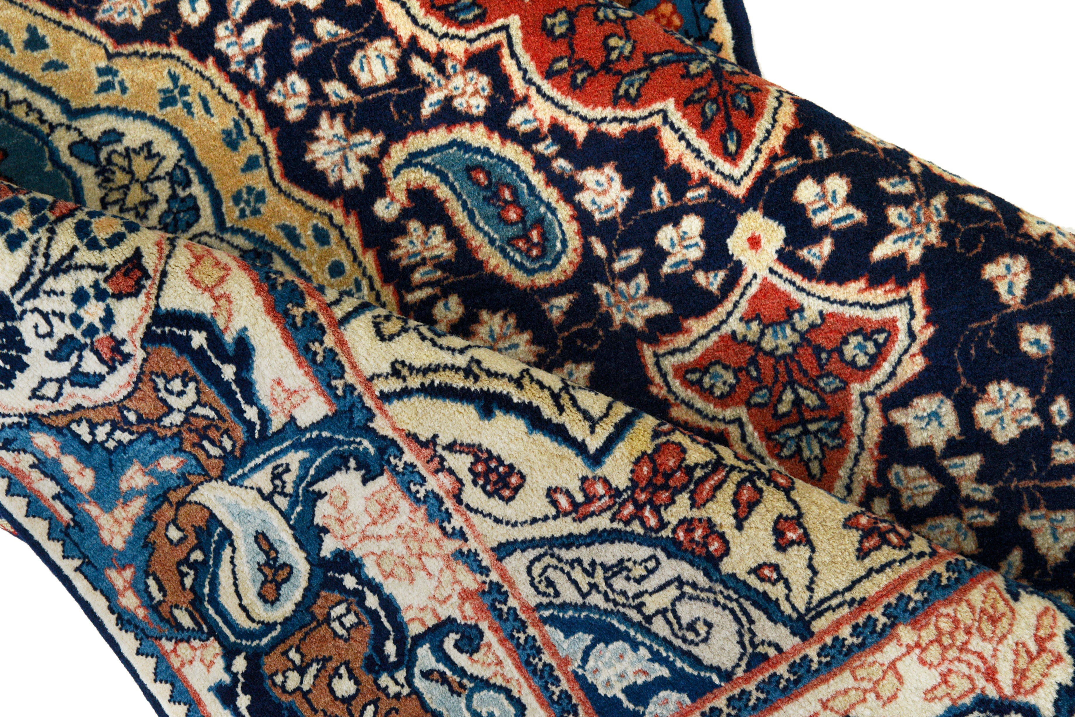 Close-up details of fine antique Persian Sarouk rug showing wool texture, motifs, and aged patina