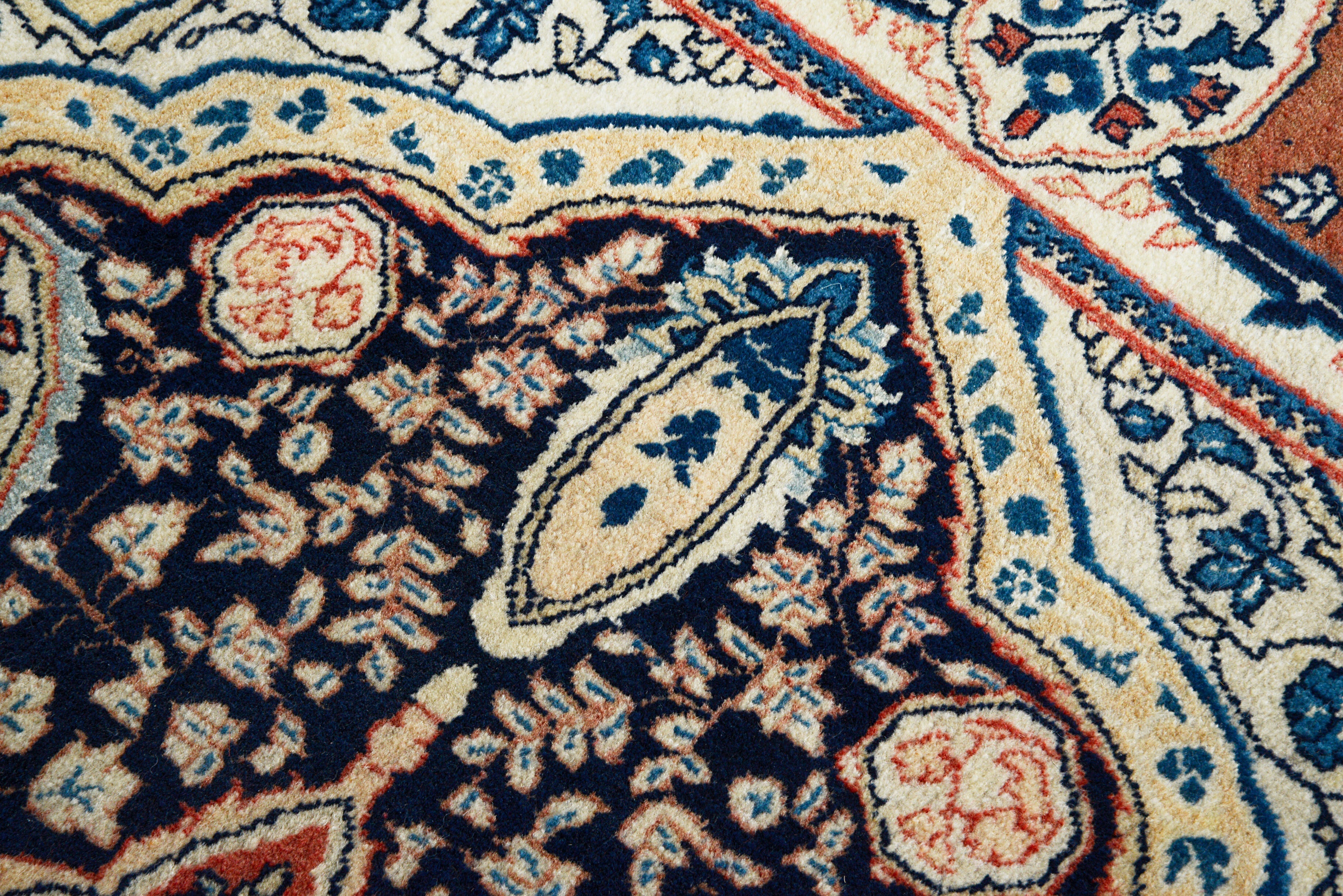 Close-up details of fine antique Persian Sarouk rug showing wool texture, motifs, and aged patina