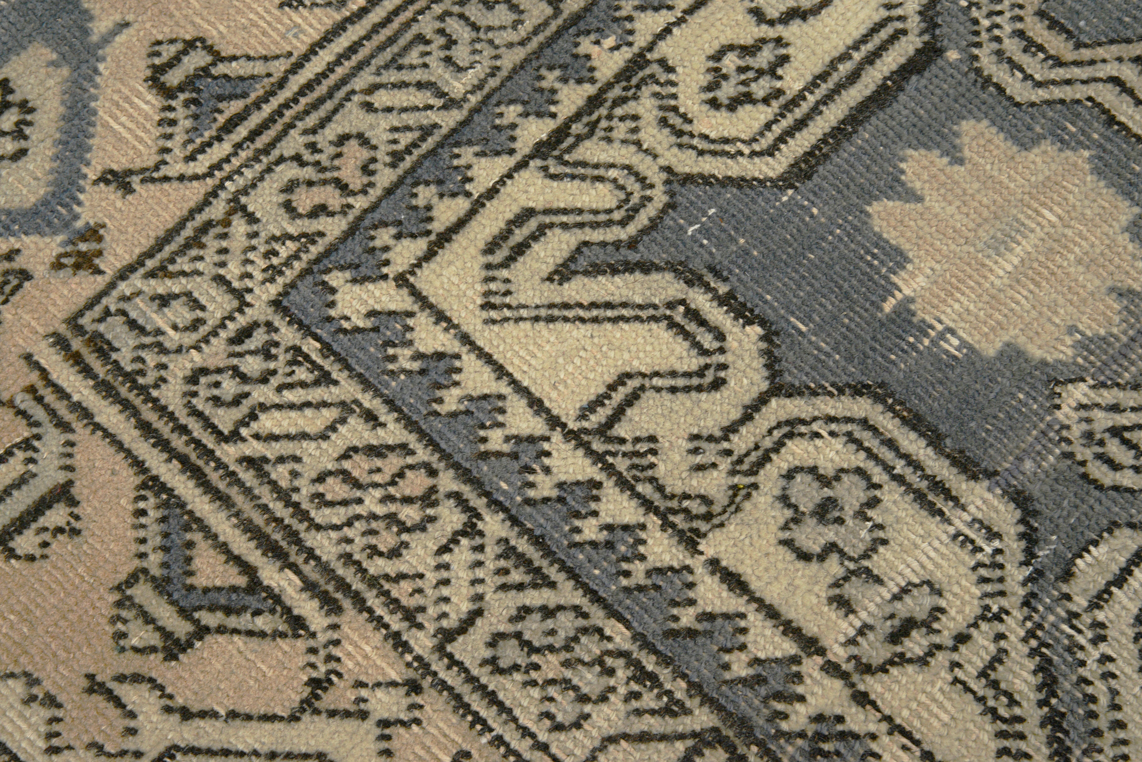 Close-up details of vintage Persian Tabriz carpet showing wool texture, motifs, and natural patina