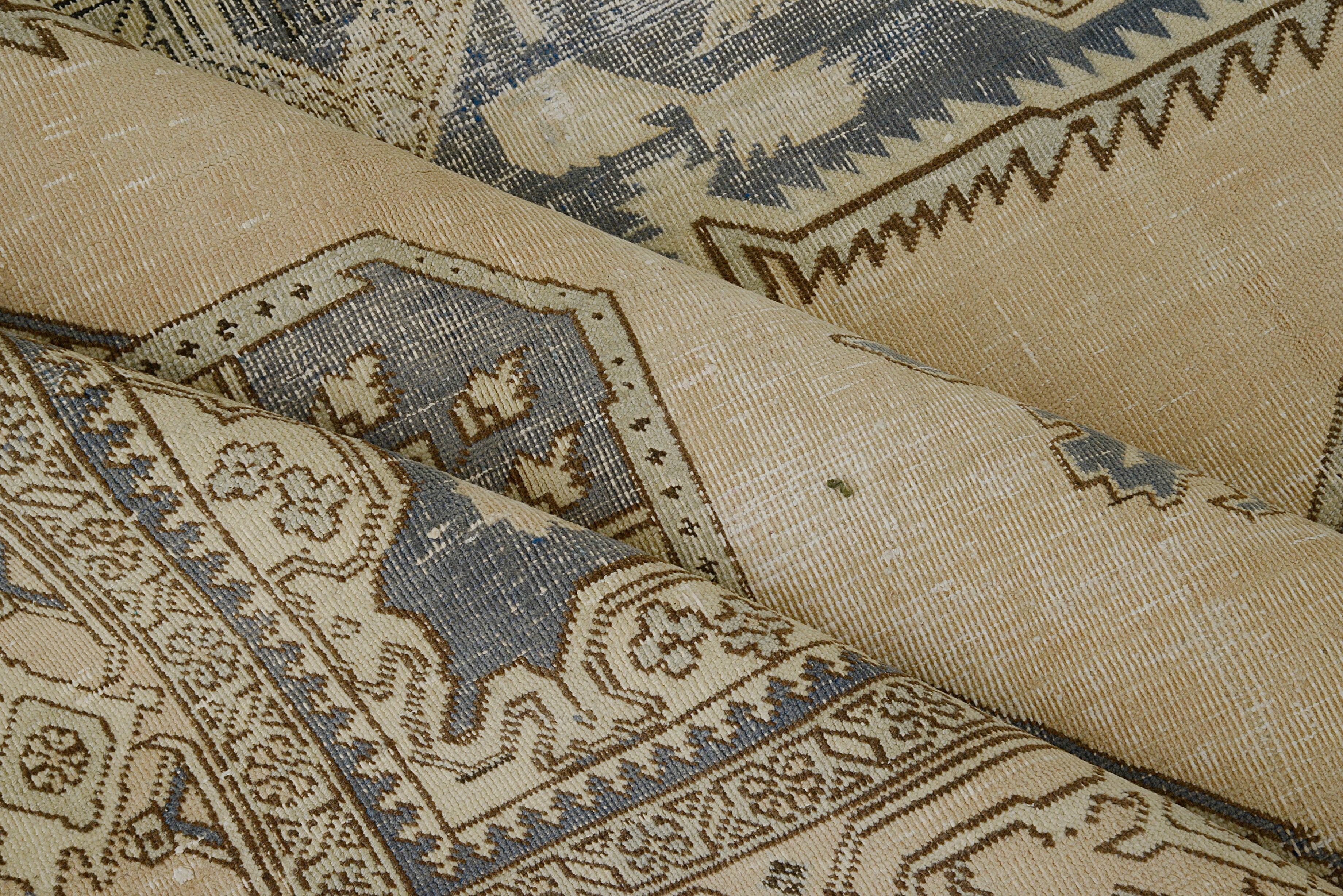 Close-up details of vintage Persian Tabriz carpet showing wool texture, motifs, and natural patina