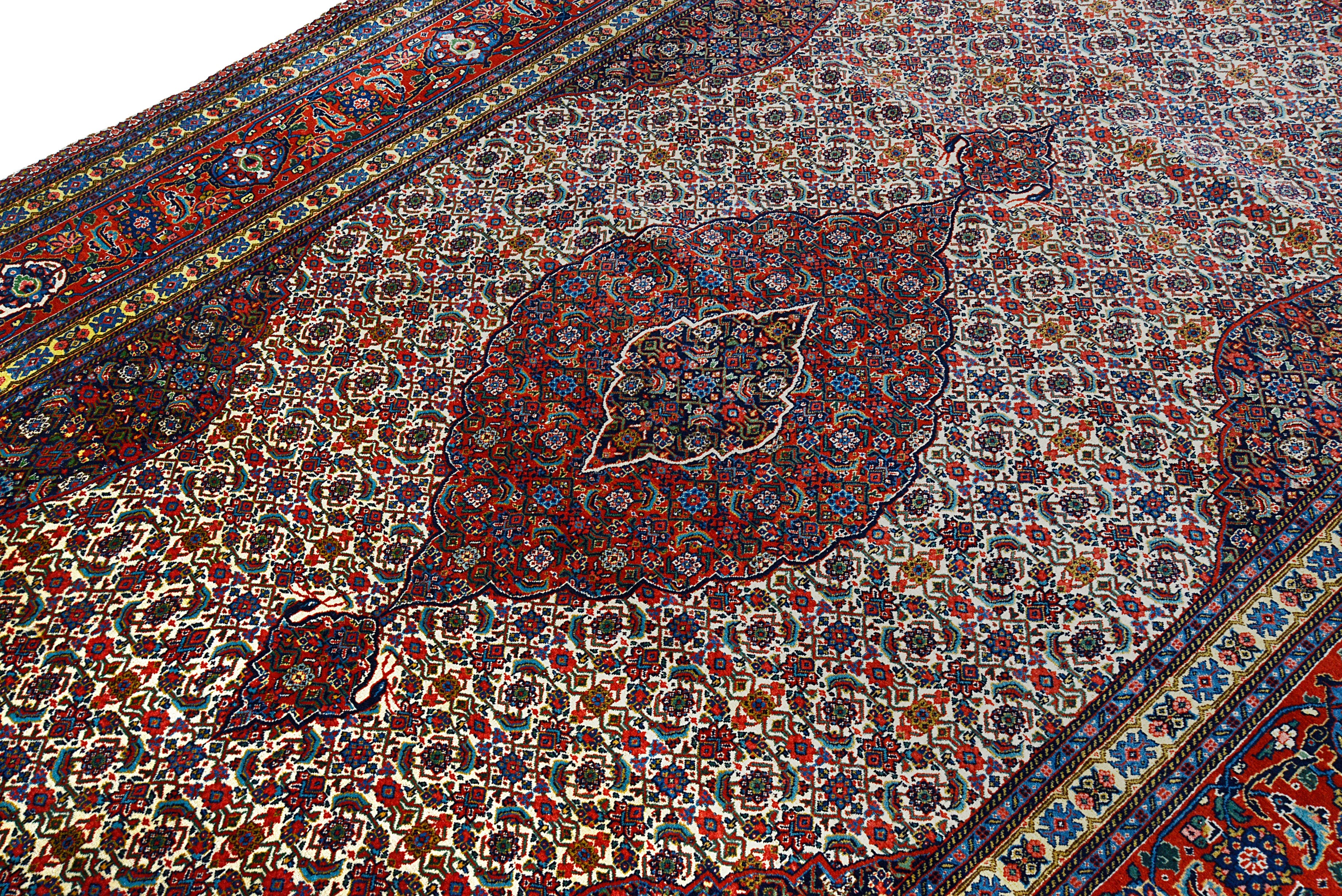 Close-up details of vintage Persian Tabriz carpet showing fine wool texture, motifs, and natural patina