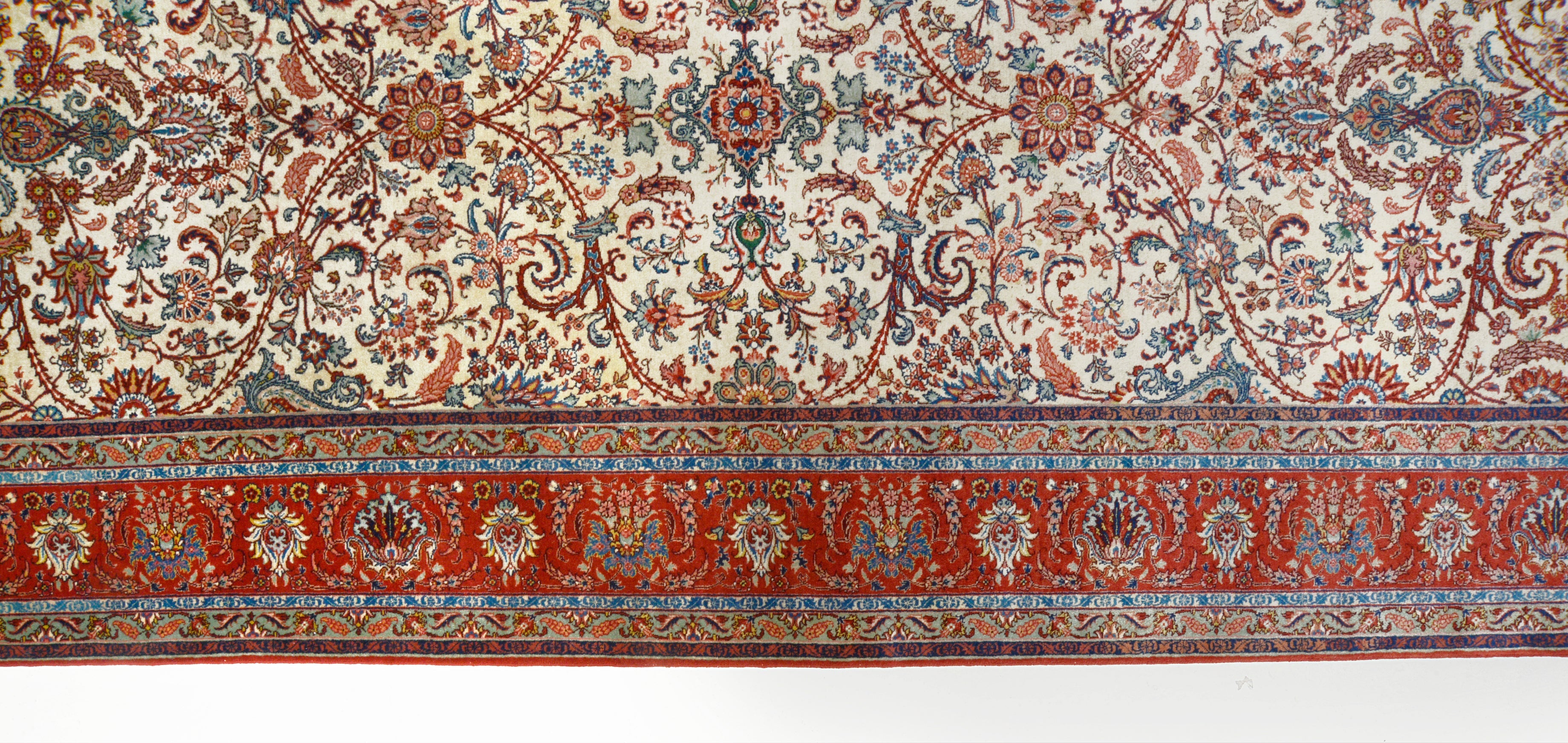 Close-up details of fine antique Persian Tabriz rug showing wool texture, floral motifs, and aged patina