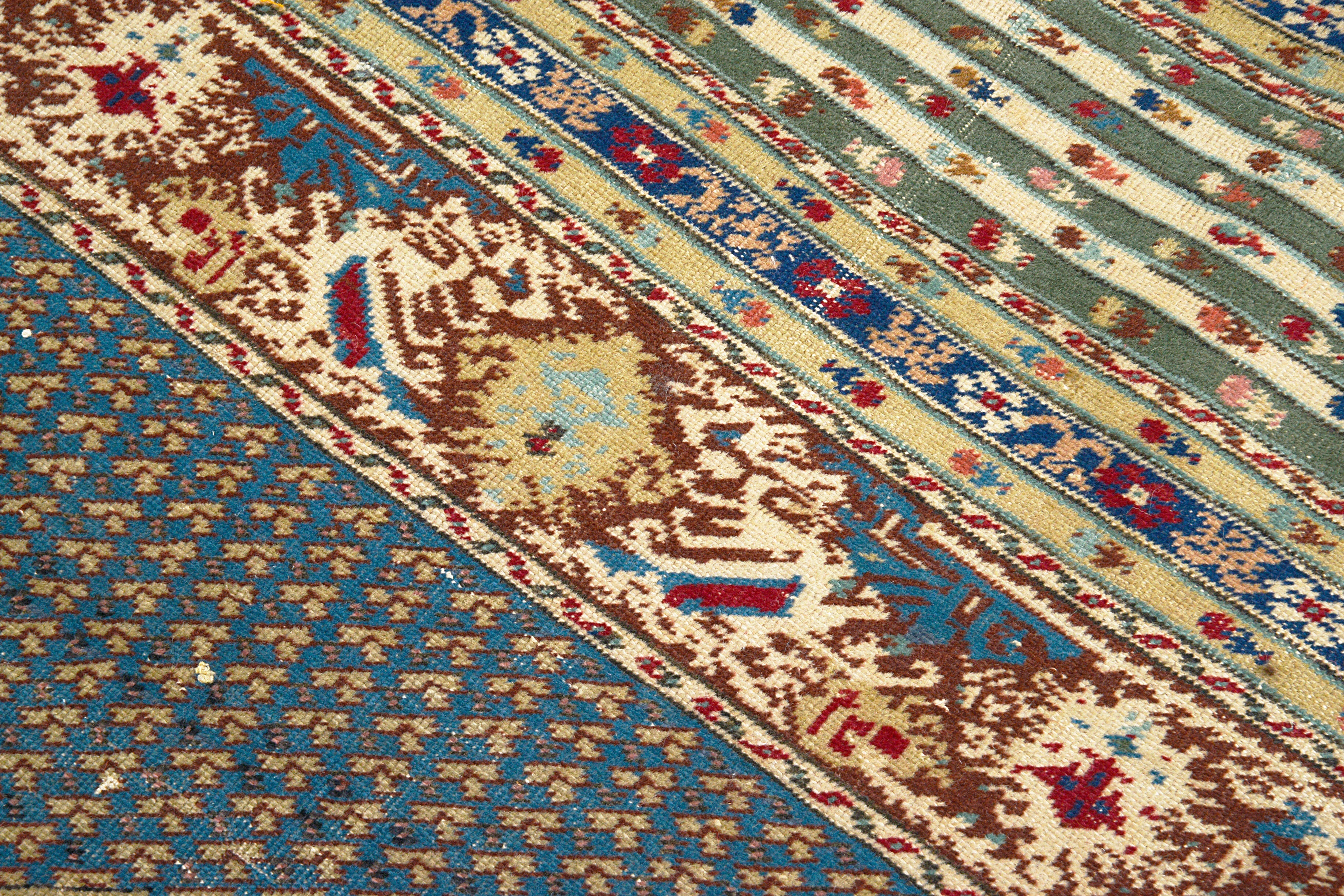 Close-up details of antique Turkish rug showing wool texture, motifs, and natural patina