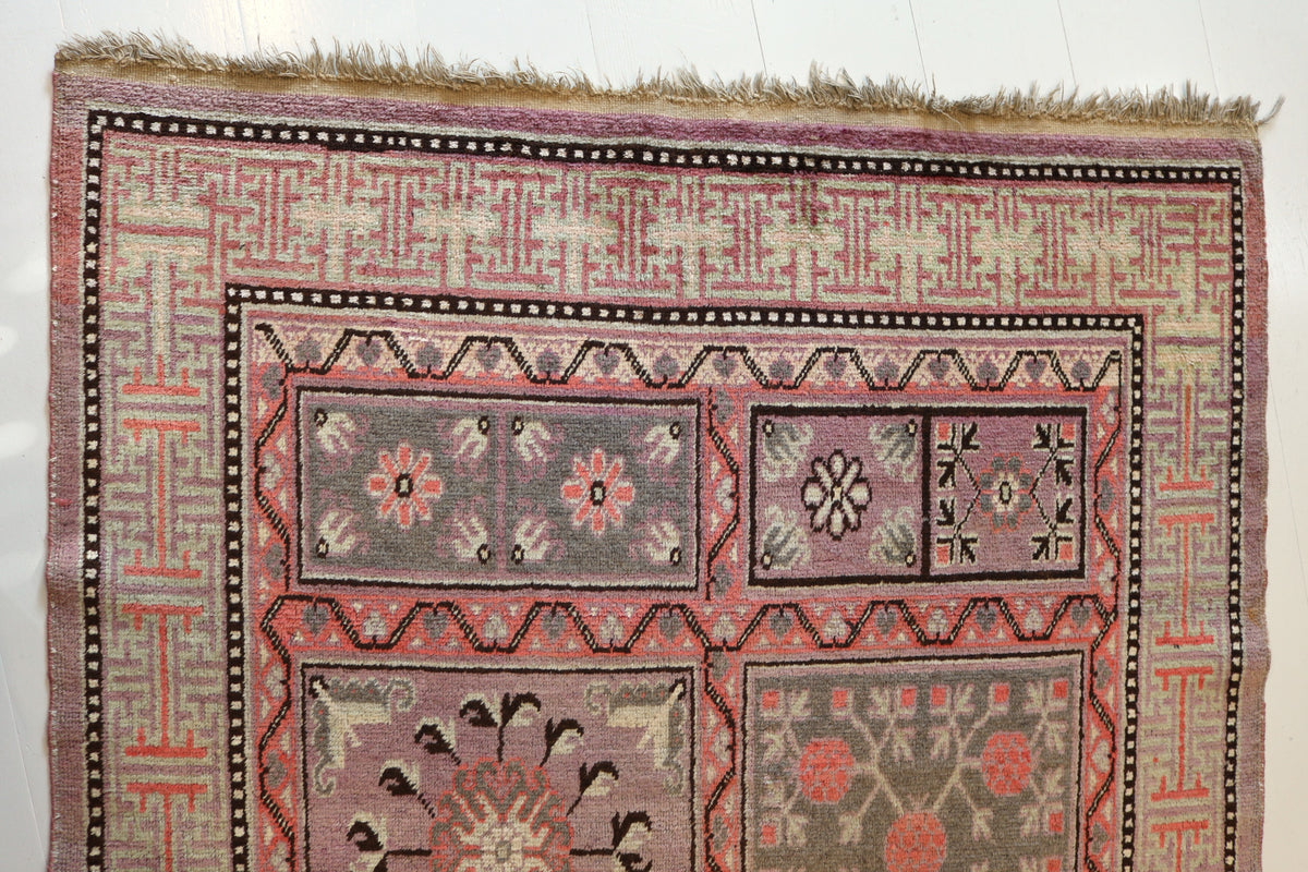 Detailed rug section featuring floral medallions and geometric patterns