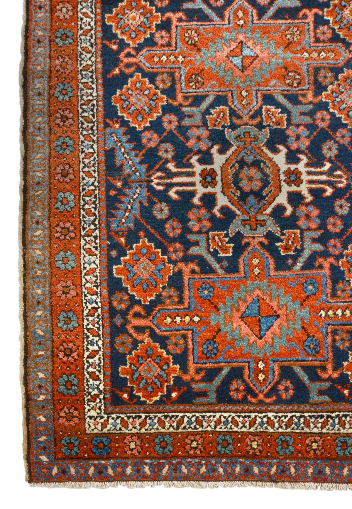 Antique Persian Heriz rug with deep indigo field, terracotta geometric motifs and detailed border