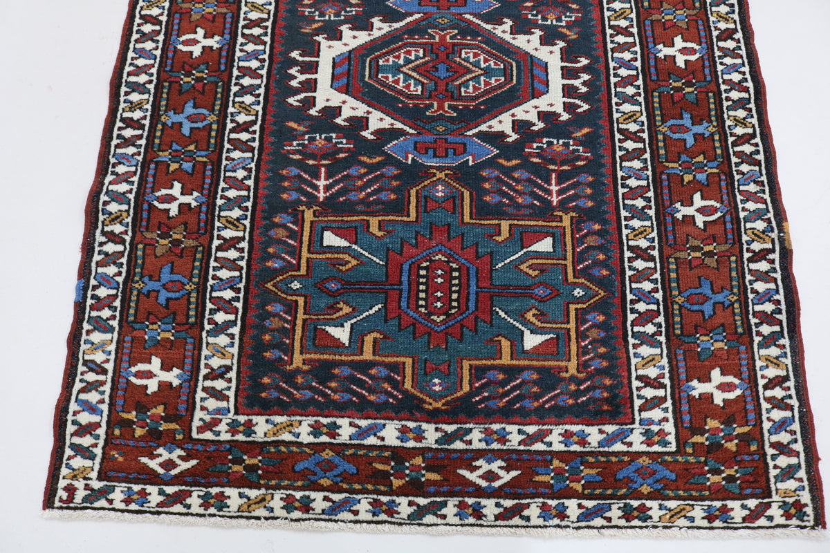 Close-up of antique Heriz runner with geometric motifs in indigo, red and ivory