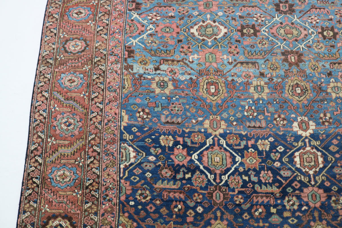 Close-up of antique Bakshayesh carpet with blue field and rust border