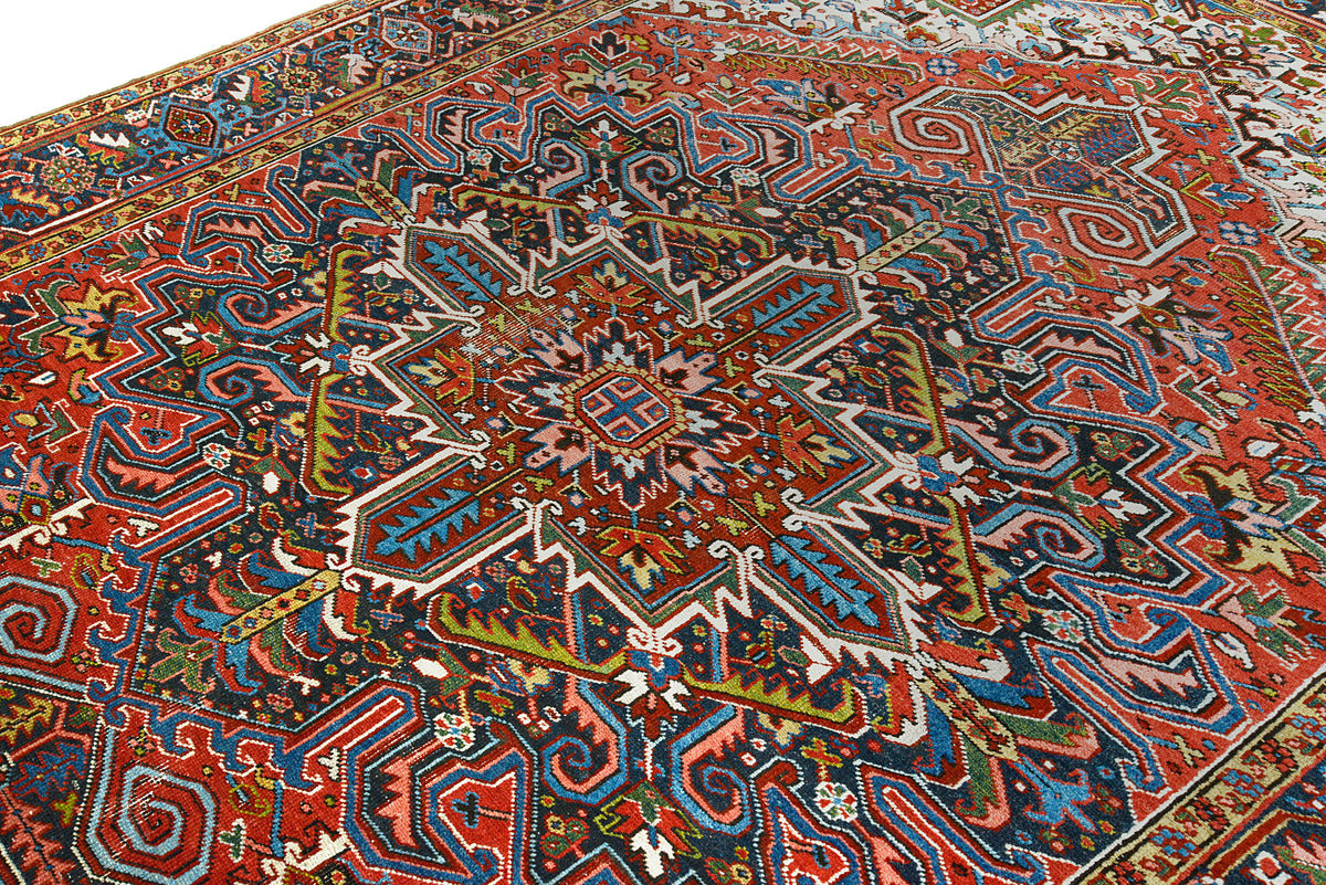 Close-up of Persian Heriz carpet field with dense geometric and floral motifs