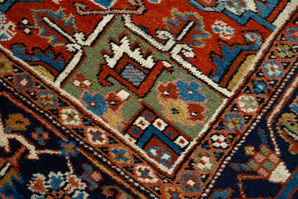 Detailed view of Heriz carpet showing angular geometric motifs and subtle abrash tones