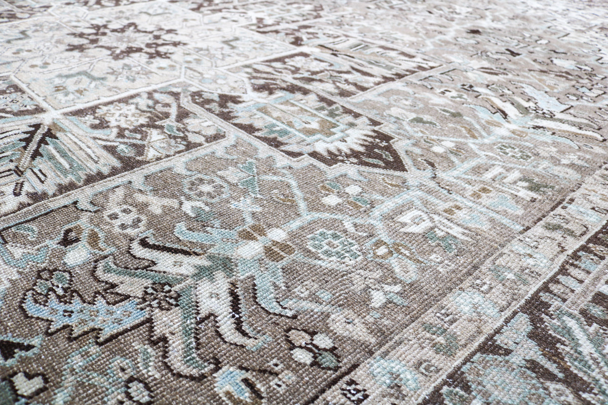 Close-up of Persian Heriz carpet with intricate motifs and naturally aged wool texture
