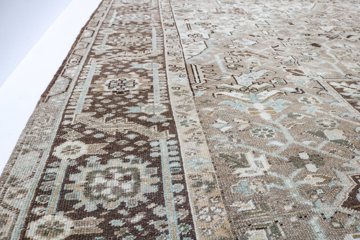 Detailed corner of antique Heriz carpet showing layered border and geometric ornamentation
