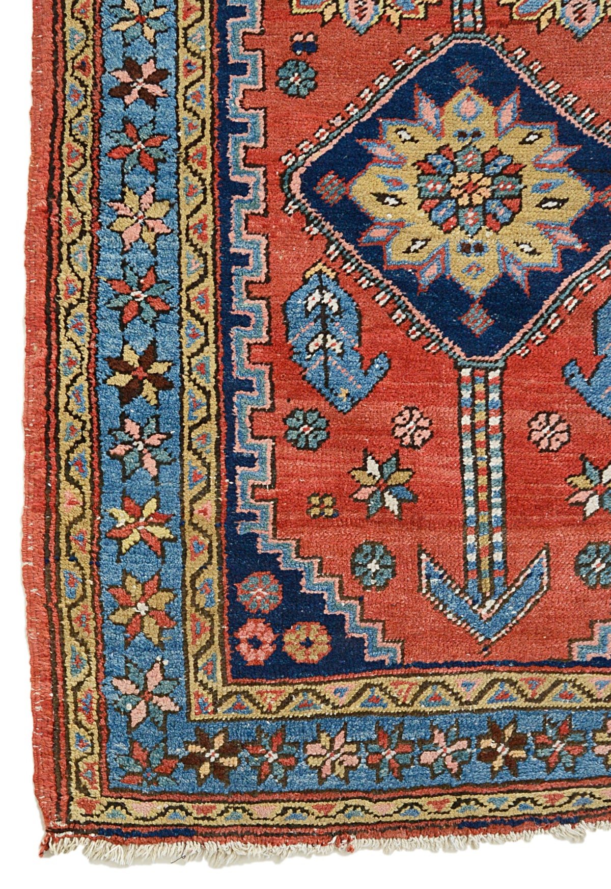 Antique Persian Heriz runner with terracotta-red field, bold geometric motifs and blue floral border