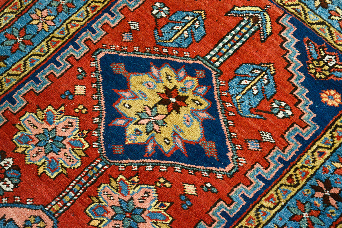Close-up of Heriz runner featuring central floral medallion and angular geometric patterns