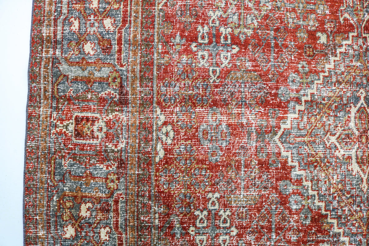 Close-up of antique Josheqan rug showing intricate geometric and floral patterns