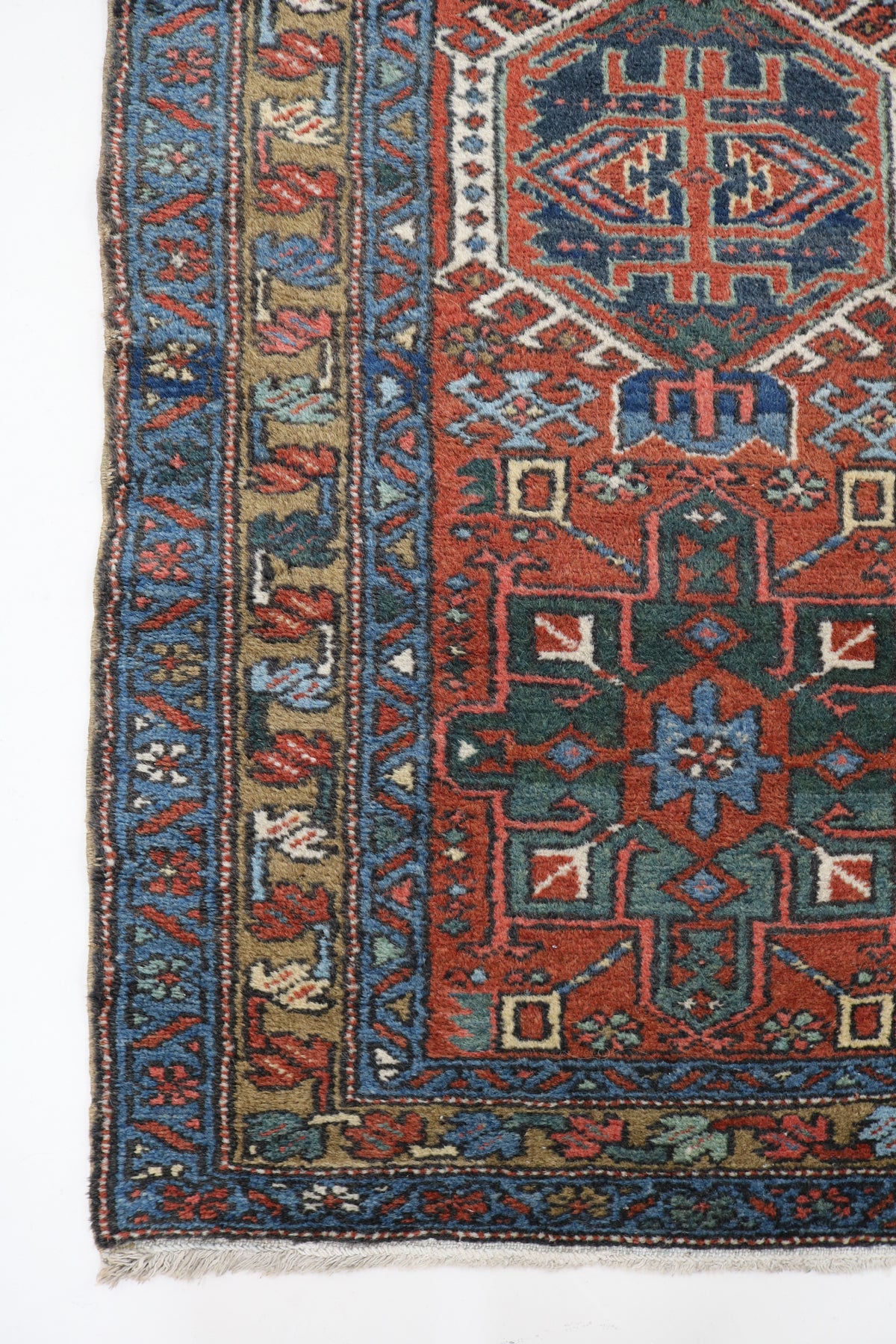 Antique Persian Karaja runner with rust red field, blue geometric medallions and detailed border