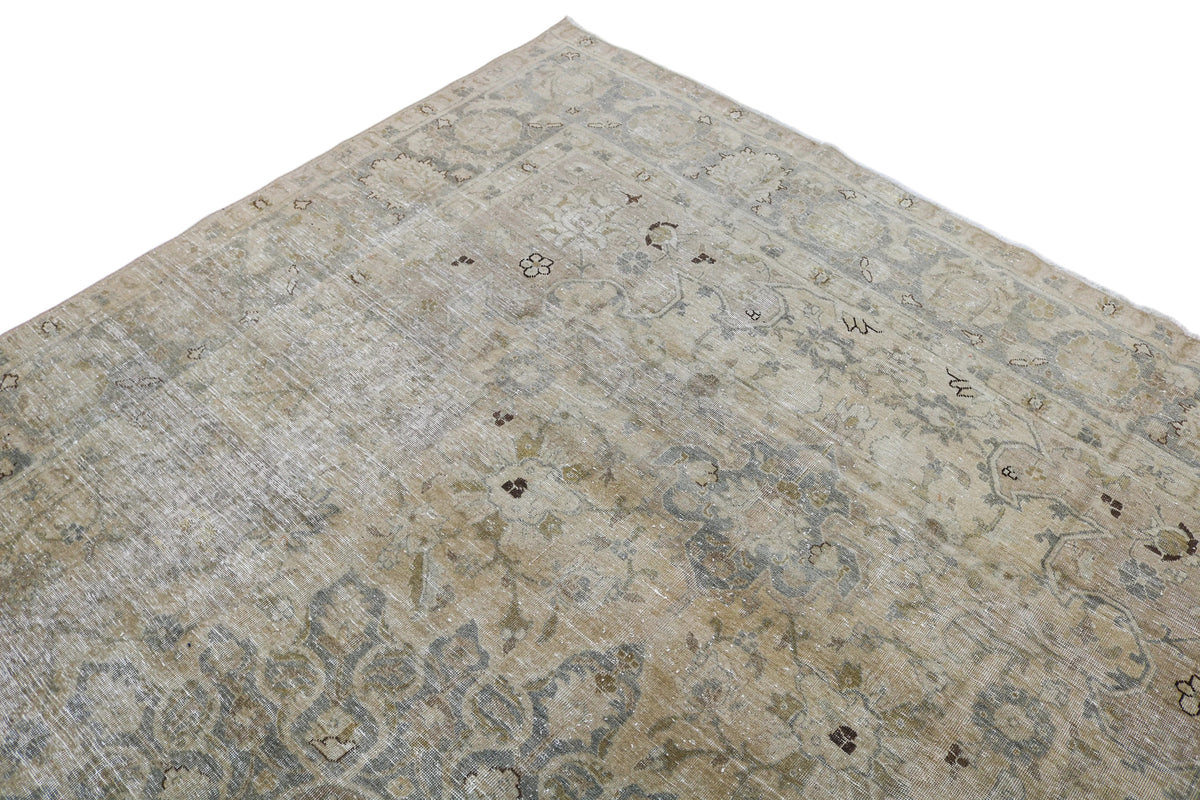 Detailed corner of Persian Tabriz carpet with intricate floral motifs and borders