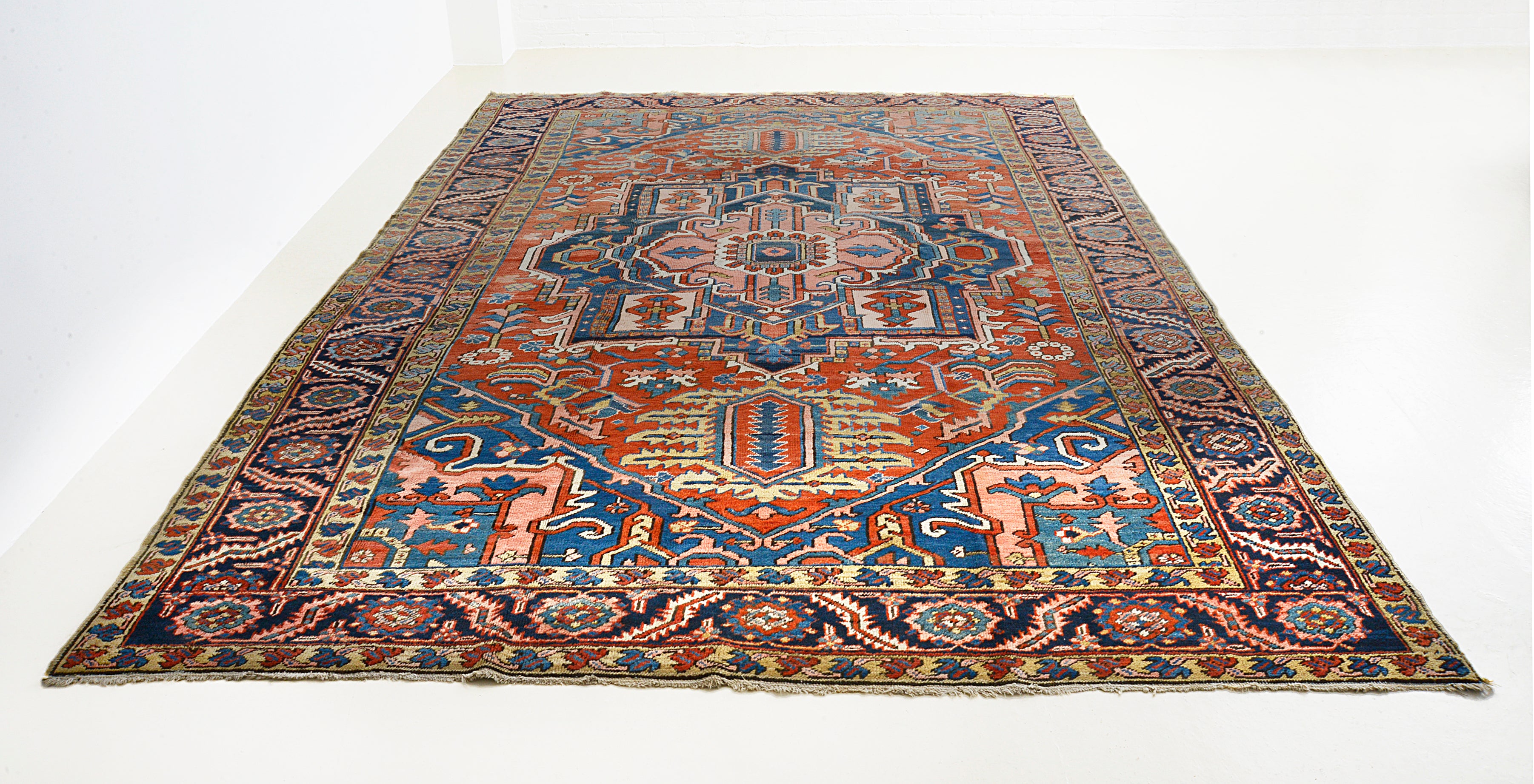 Full view of antique Persian Heriz carpet with architectural geometric design