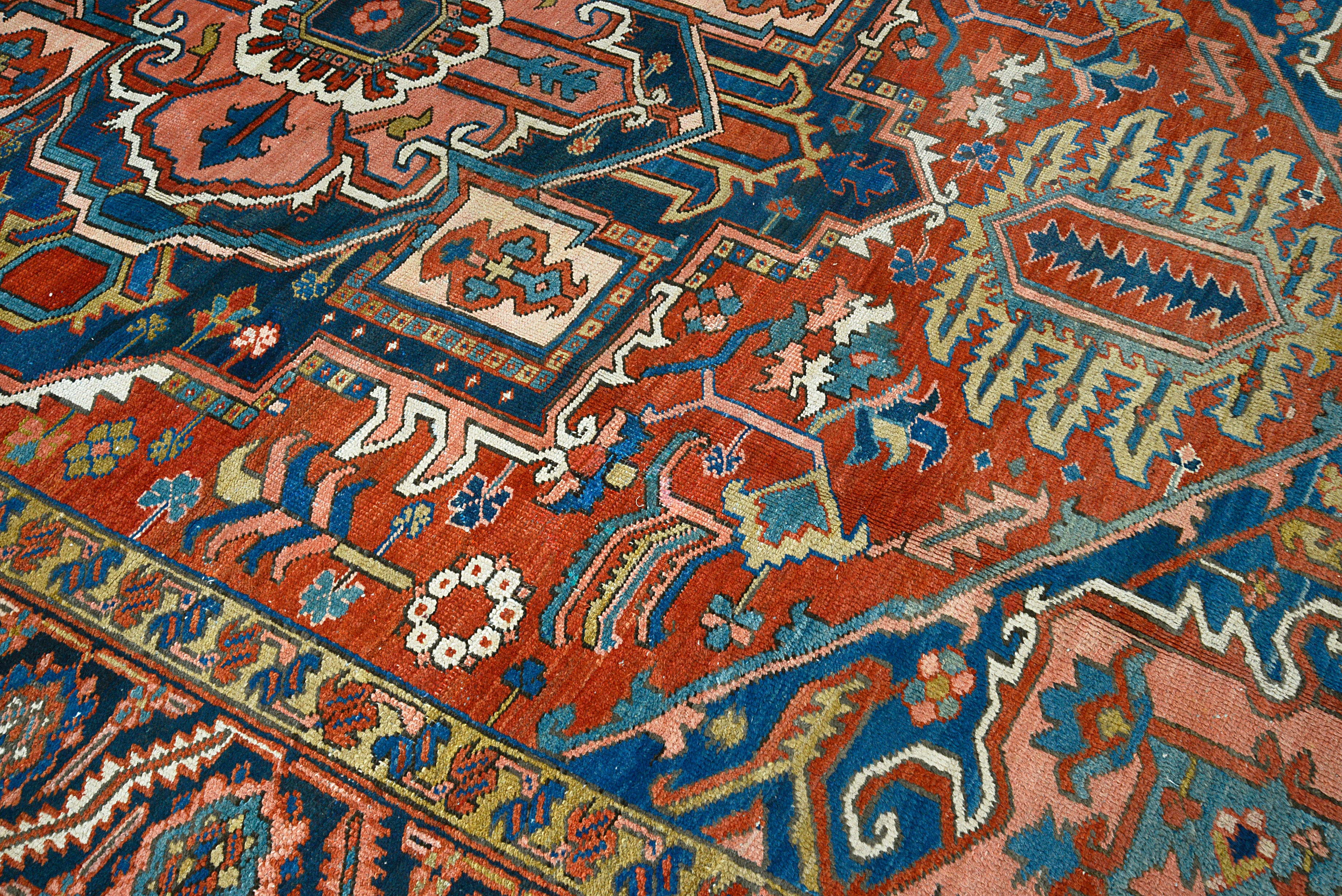 Close-up of central geometric motifs on antique Persian Heriz carpet