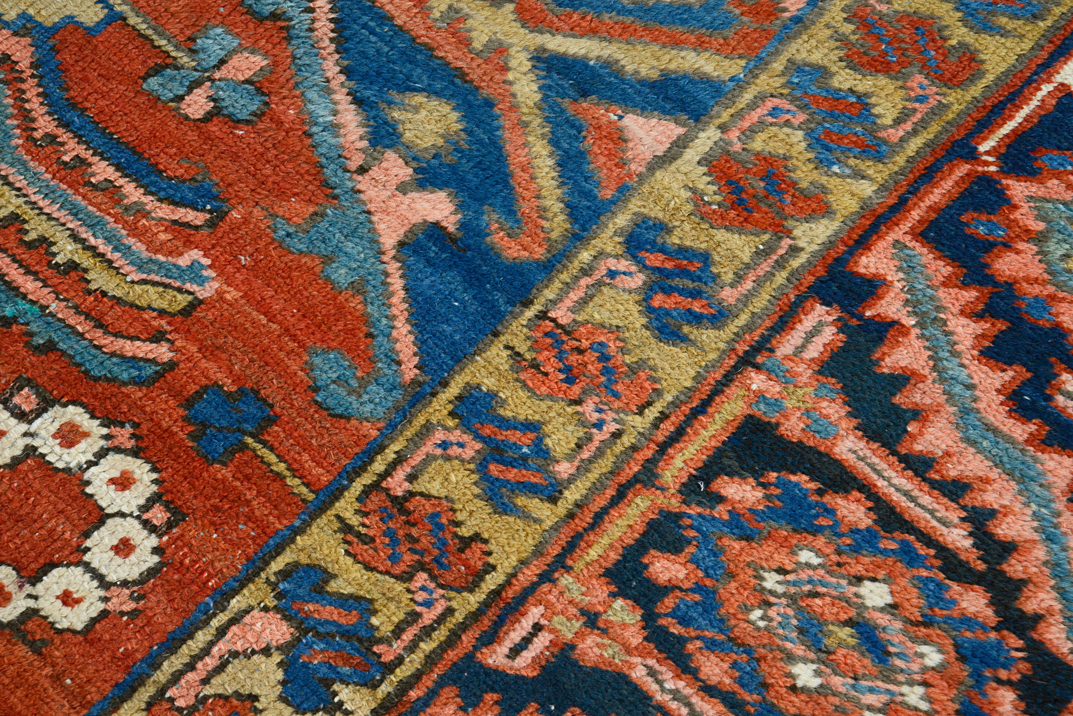 Close-up of hand-knotted wool texture on antique Persian Heriz carpet