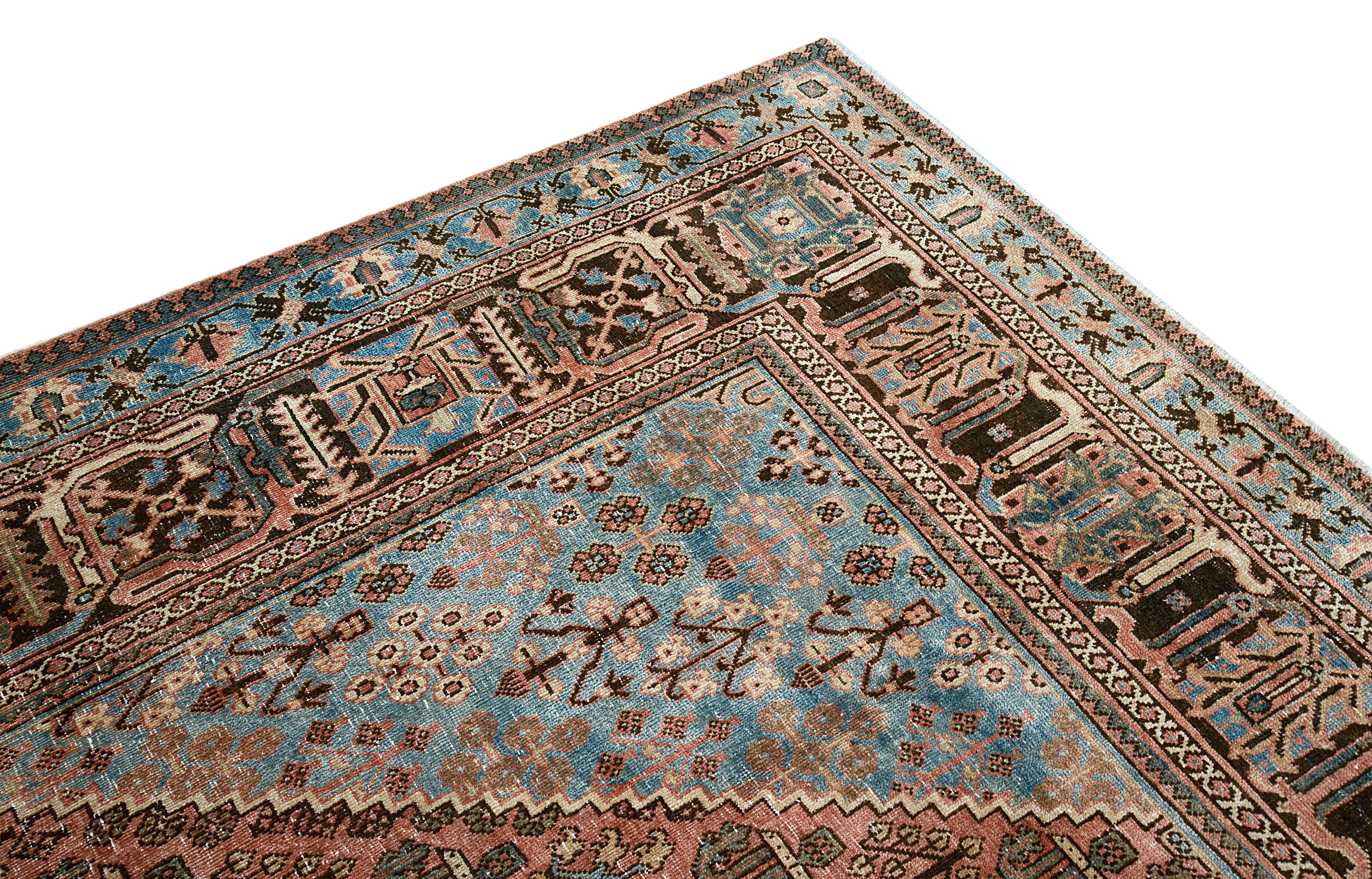 Corner view of muted colours antique Persian Josheqan rug on floor