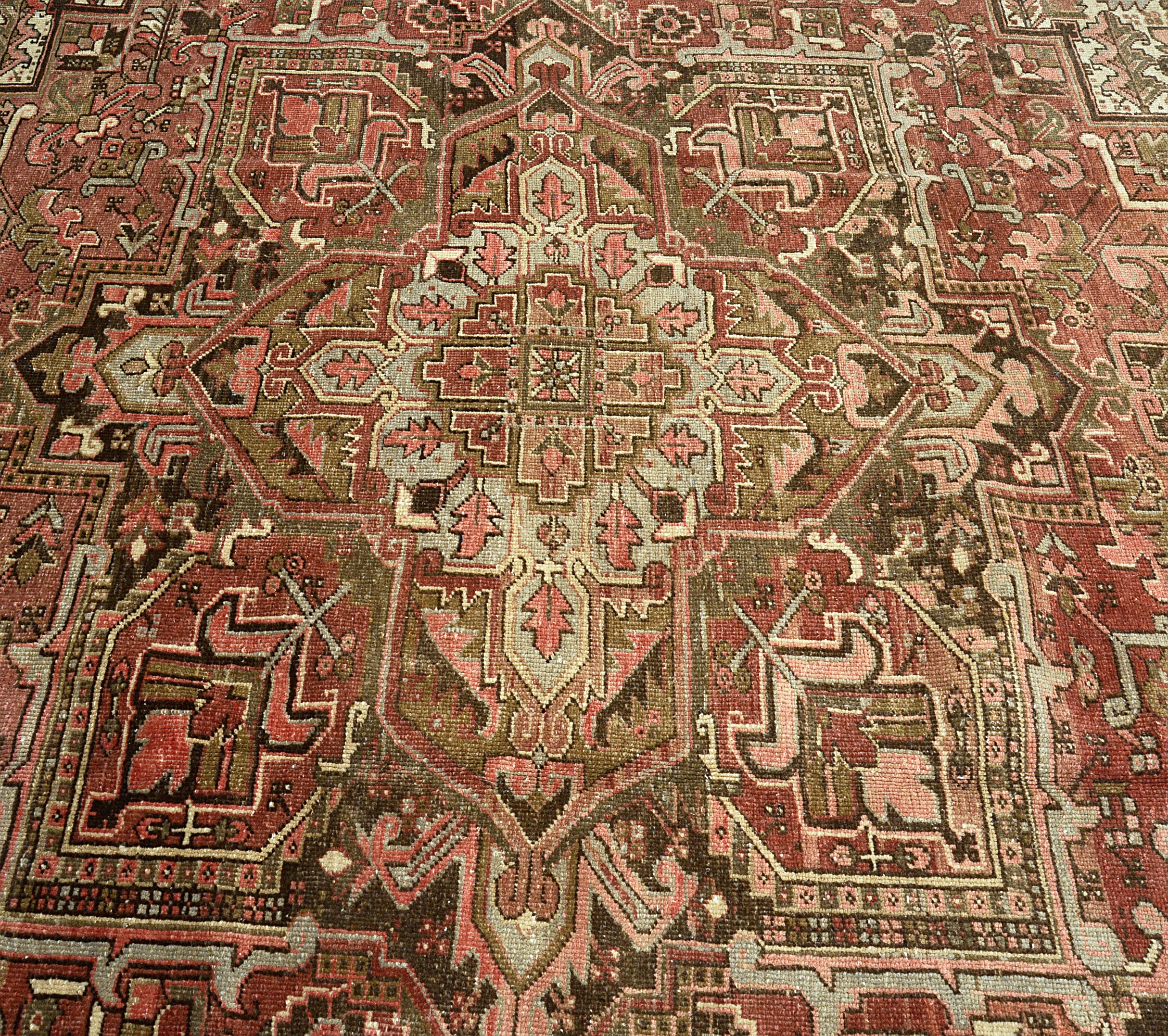 Close-up of central design area on muted colour antique Persian Heriz carpet