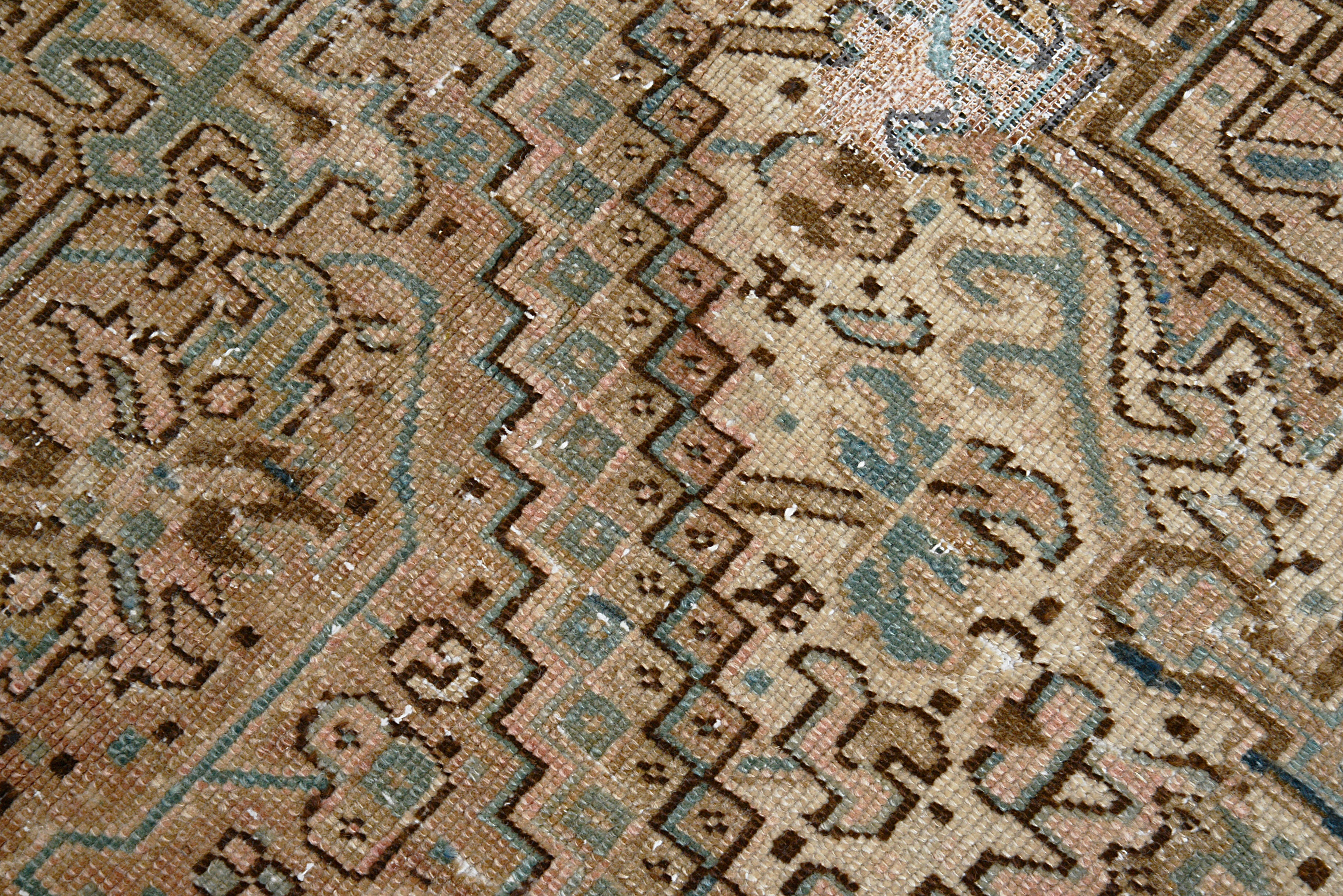 Close-up of hand-knotted wool texture on antique Persian Heriz carpet