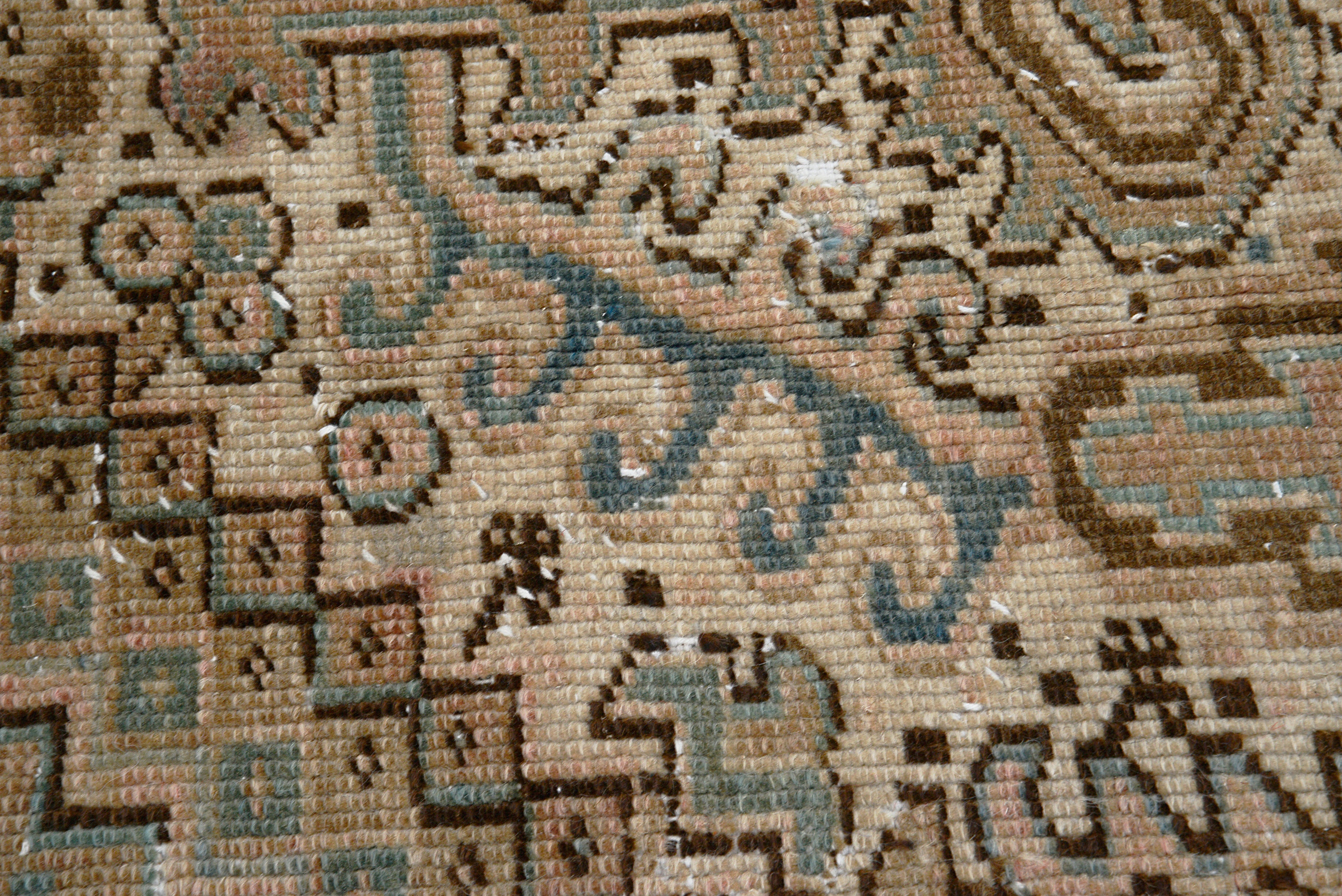 Close-up of angular motifs on antique Persian Heriz carpet