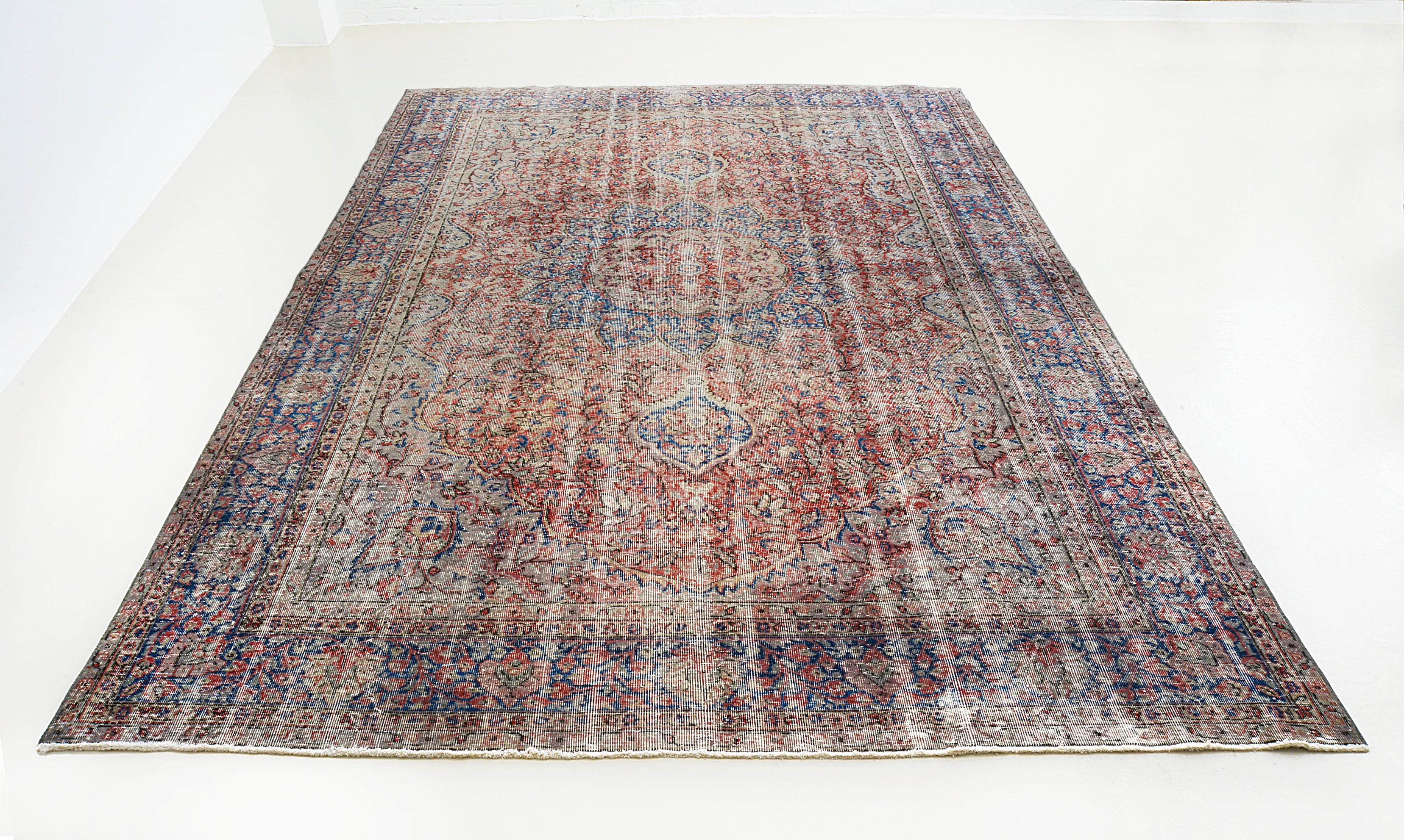 Full view of vintage Turkish carpet with all-over medallion design