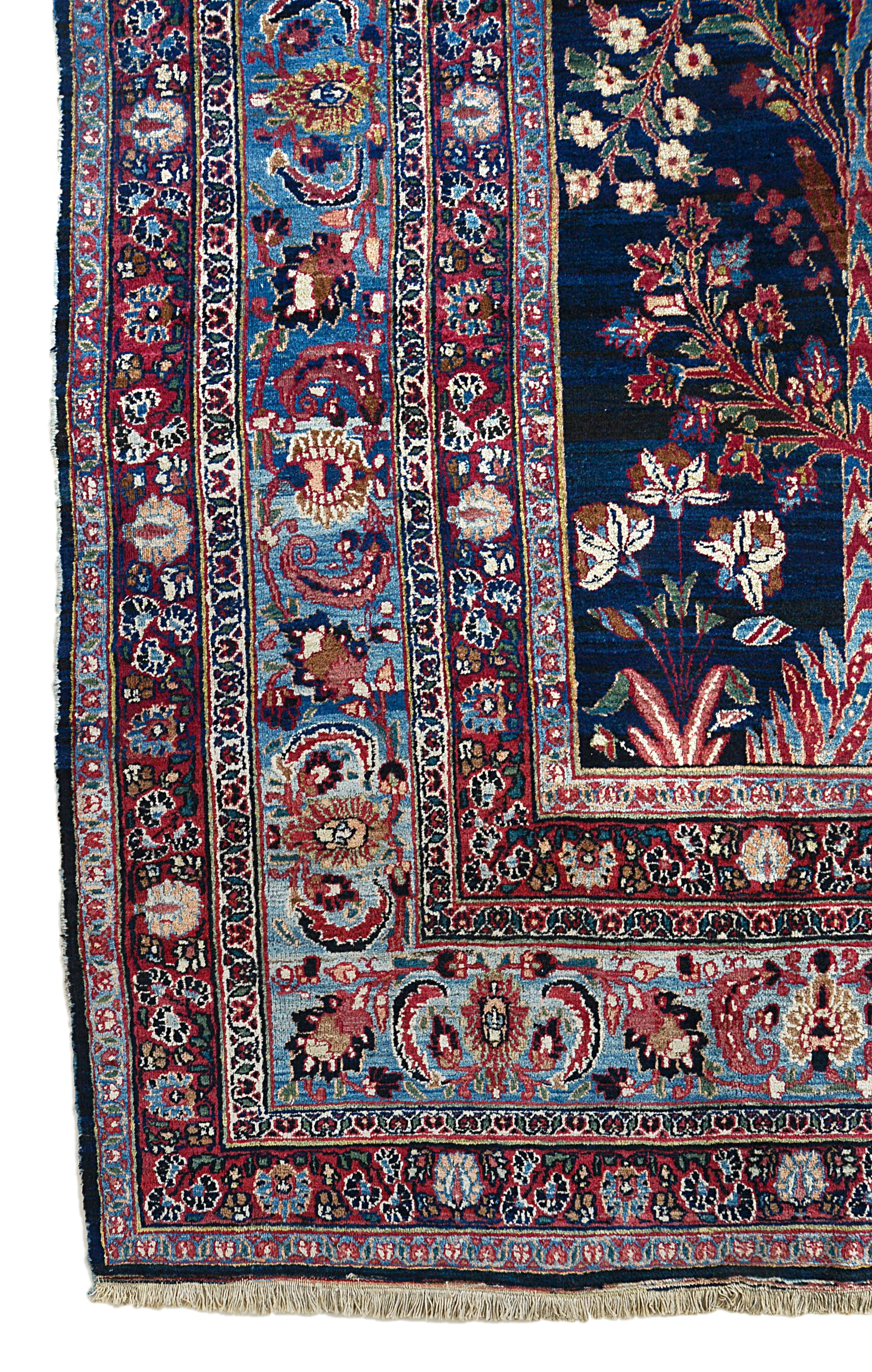 Corner view of an antique Persian Heriz carpet showing bold geometric border and field details