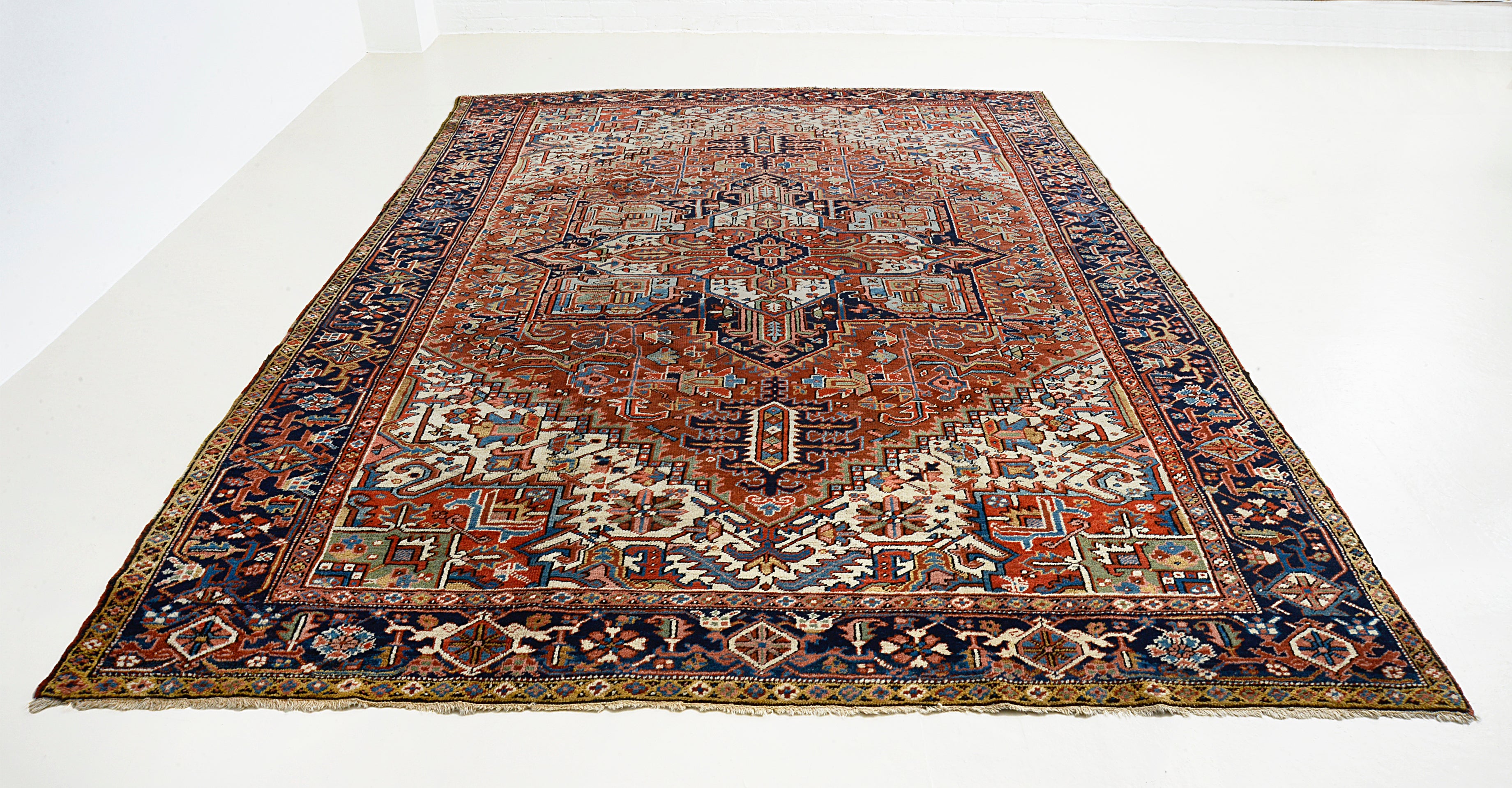 Full view of an antique Persian Heriz carpet woven circa 1920s, measuring 335 x 253 cm