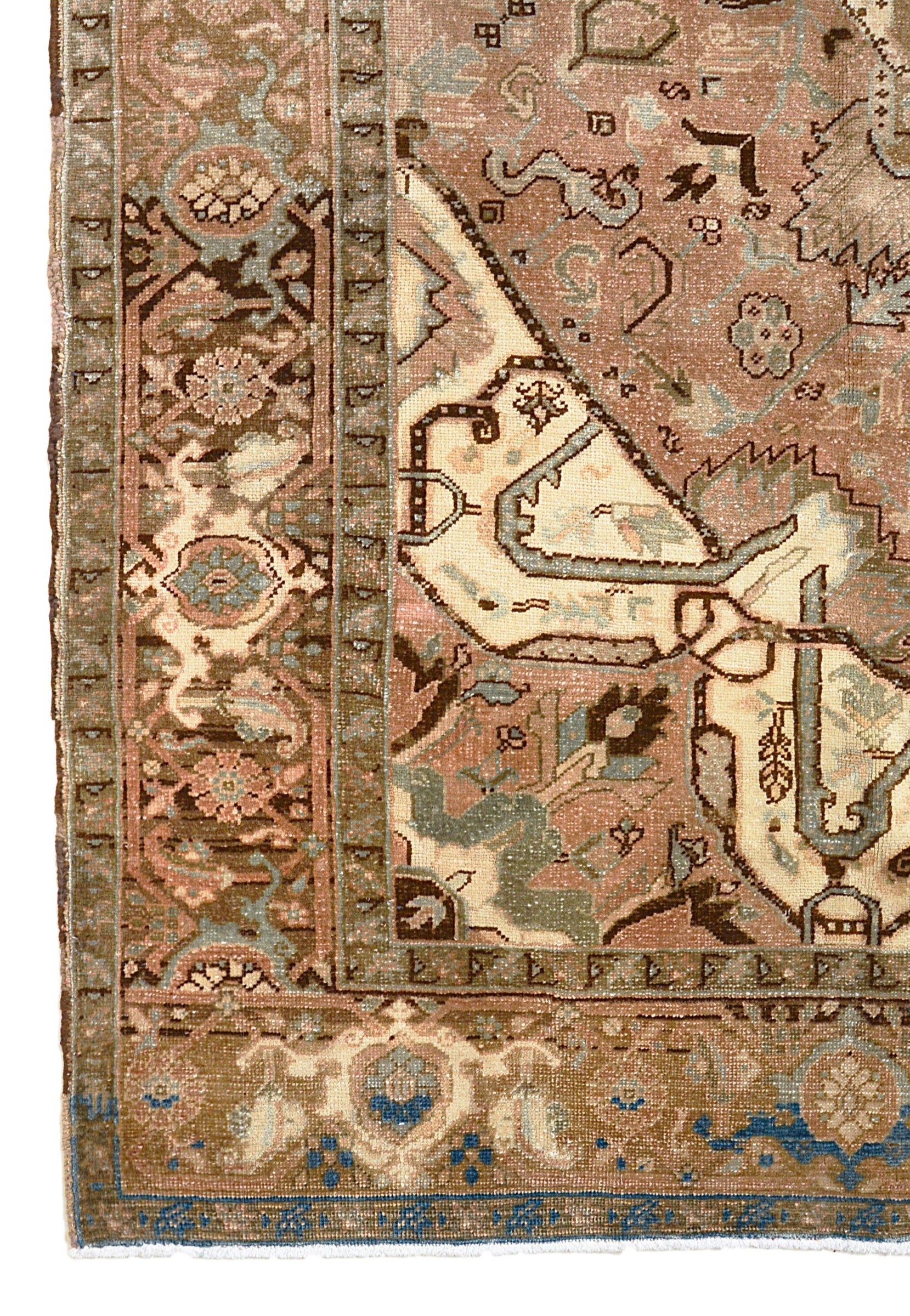 Vintage Persian Heriz carpet corner detail showing hand-knotted wool and traditional floral border