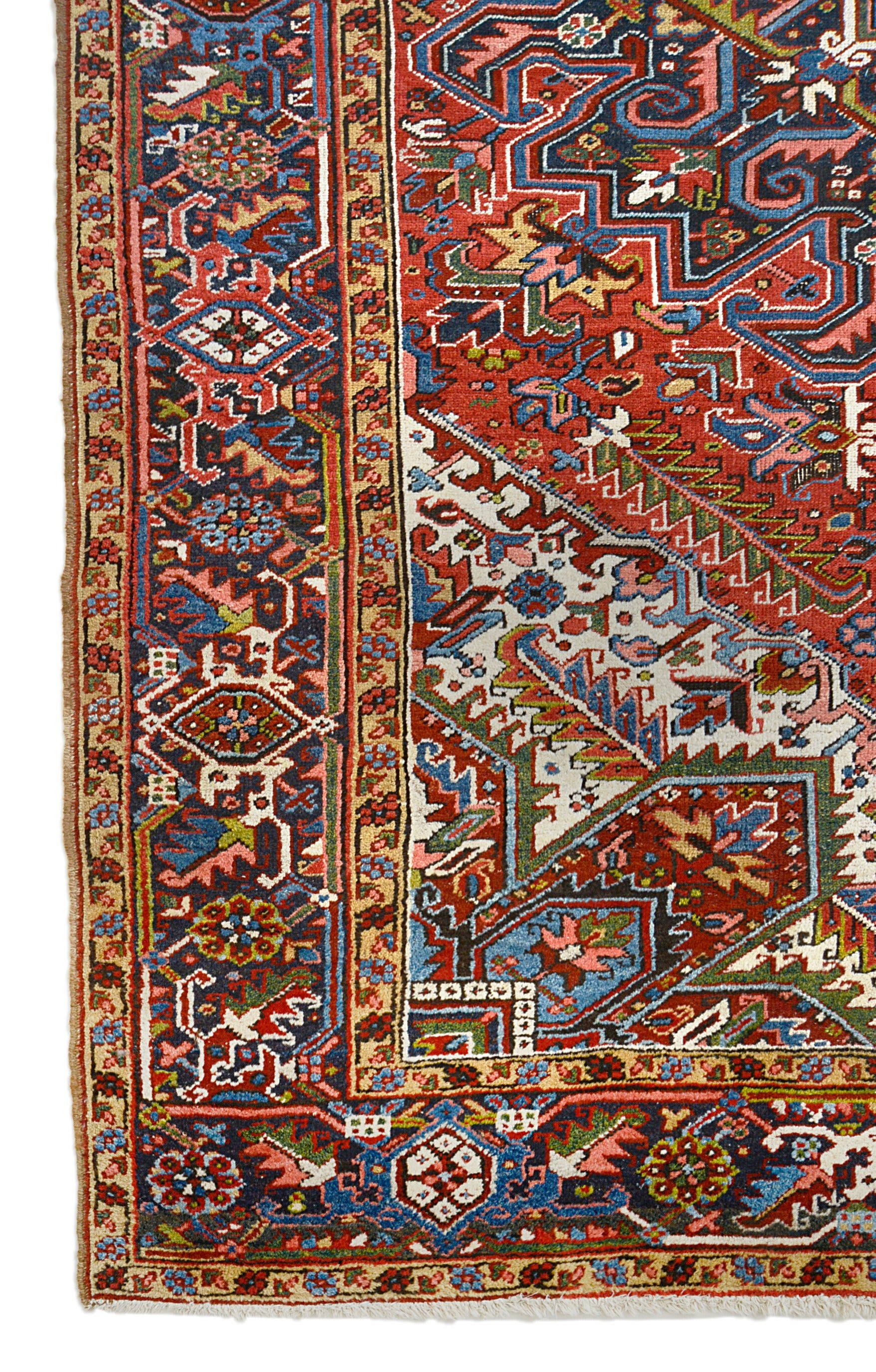 Antique Persian Heriz carpet corner detail showing hand-knotted wool and bold geometric border