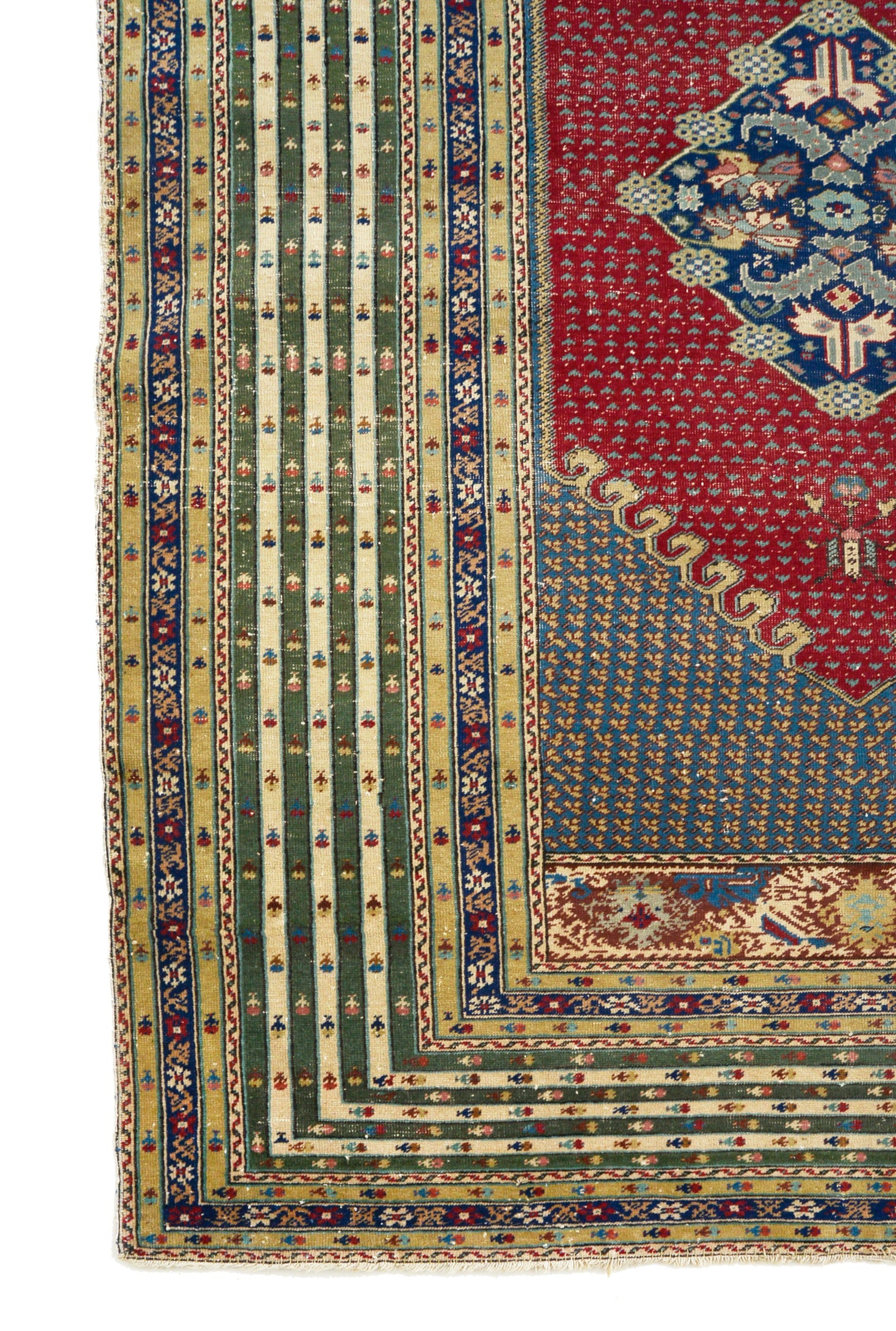 Antique Turkish rug corner detail showing hand-knotted wool and geometric border patterns