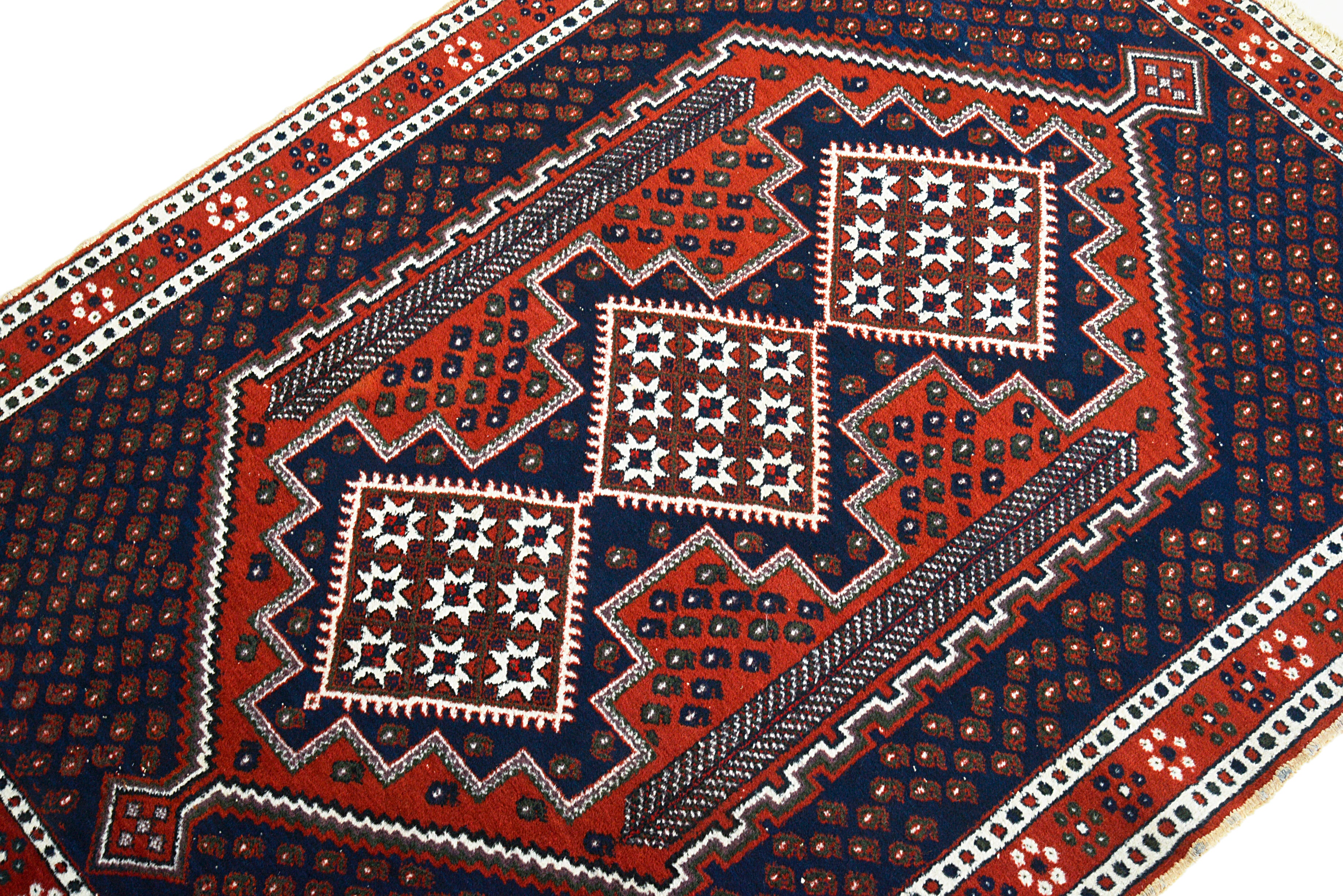 Close-up of the geometric motif detail on an antique Persian Afshar rug