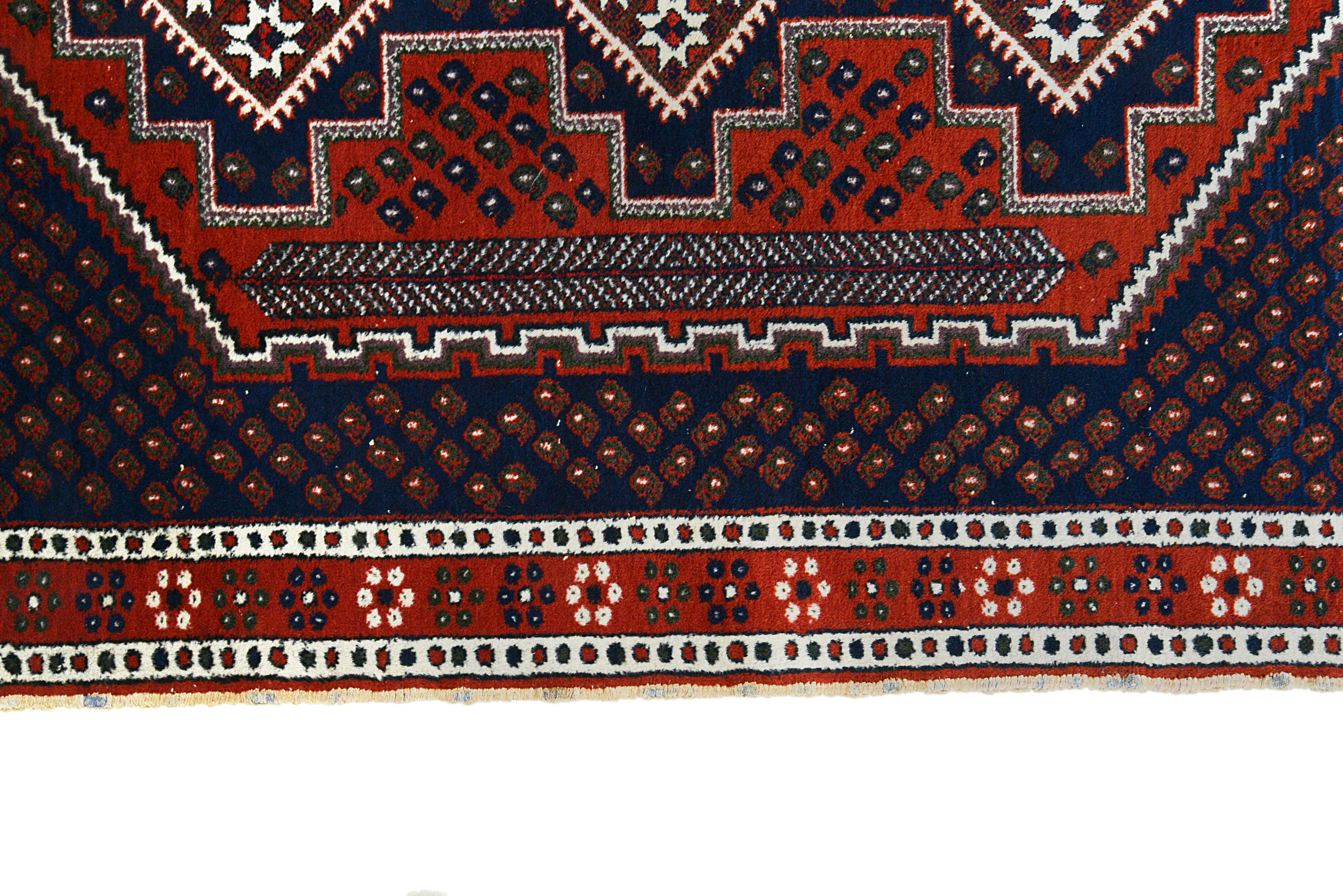 Border detail of an antique Persian Afshar rug with bold tribal patterns
