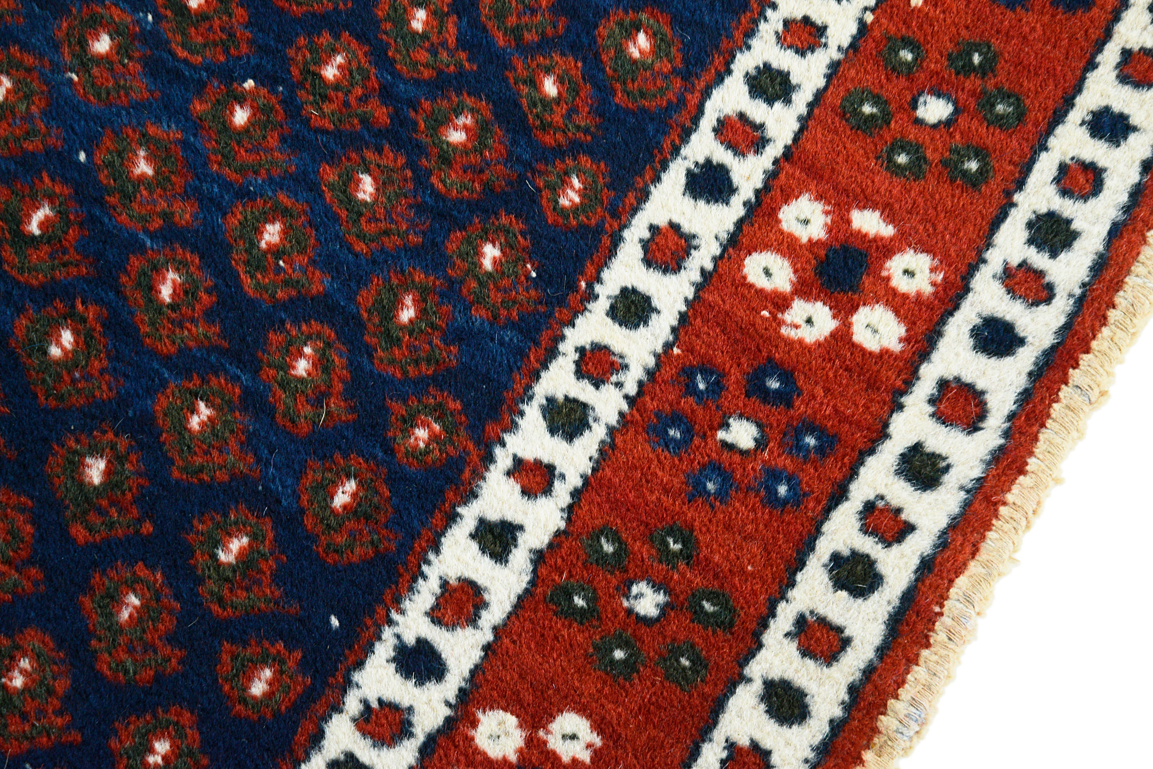 Hand-knotted wool texture of an antique Persian Afshar rug