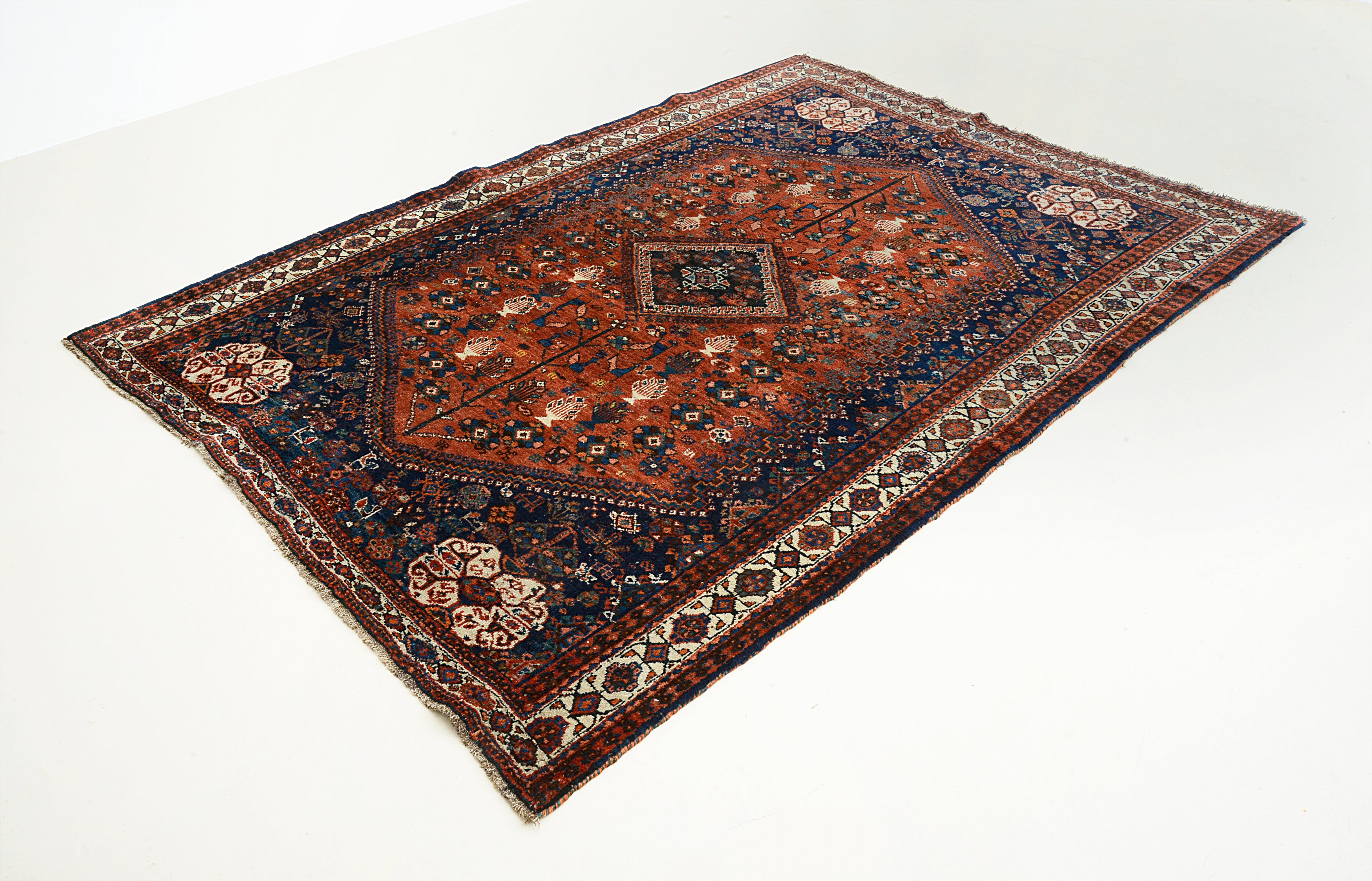 Close-up of the central field design on an antique Persian Qashqai carpet