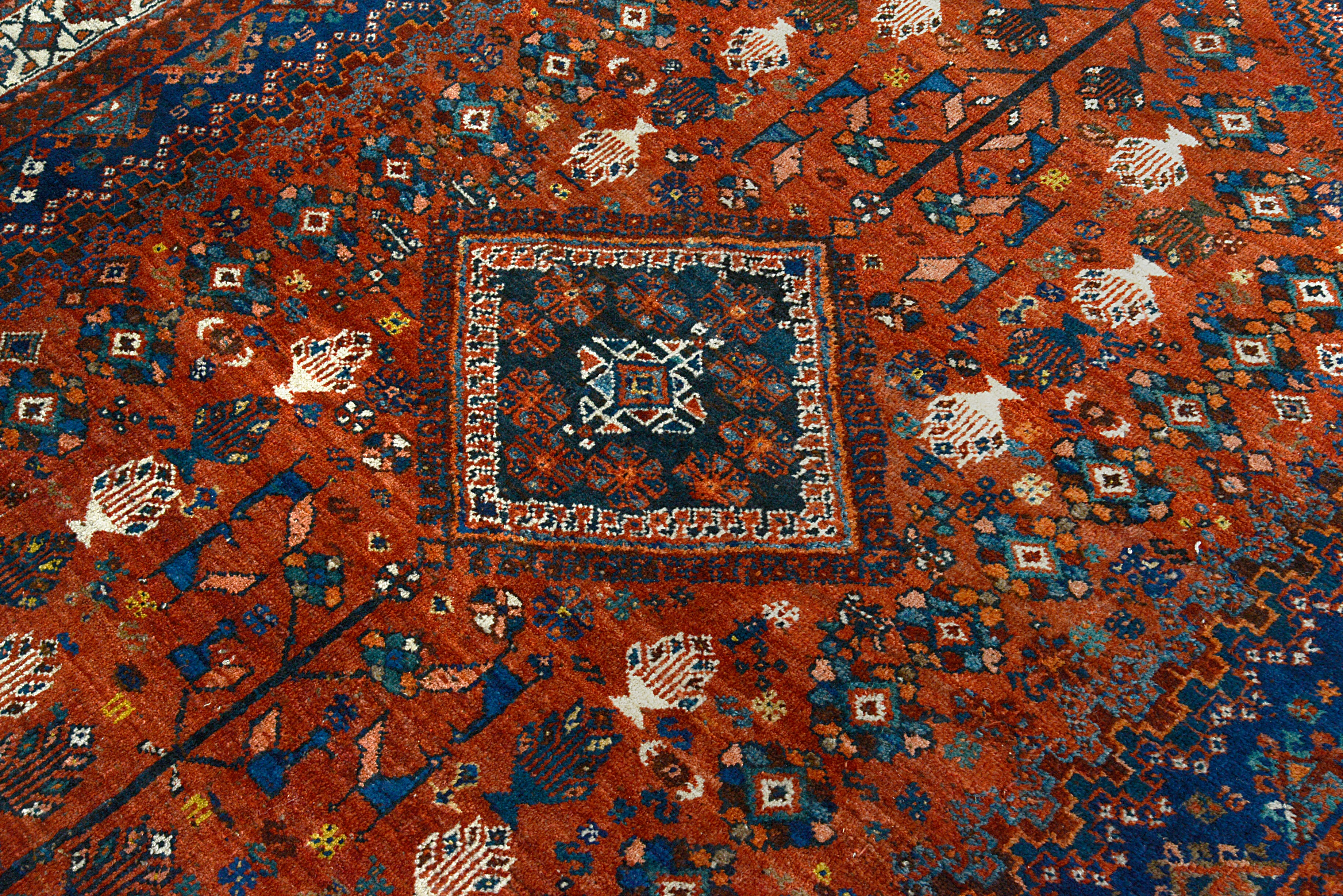 Close-up of the central medallion motif on an antique Persian Qashqai carpet