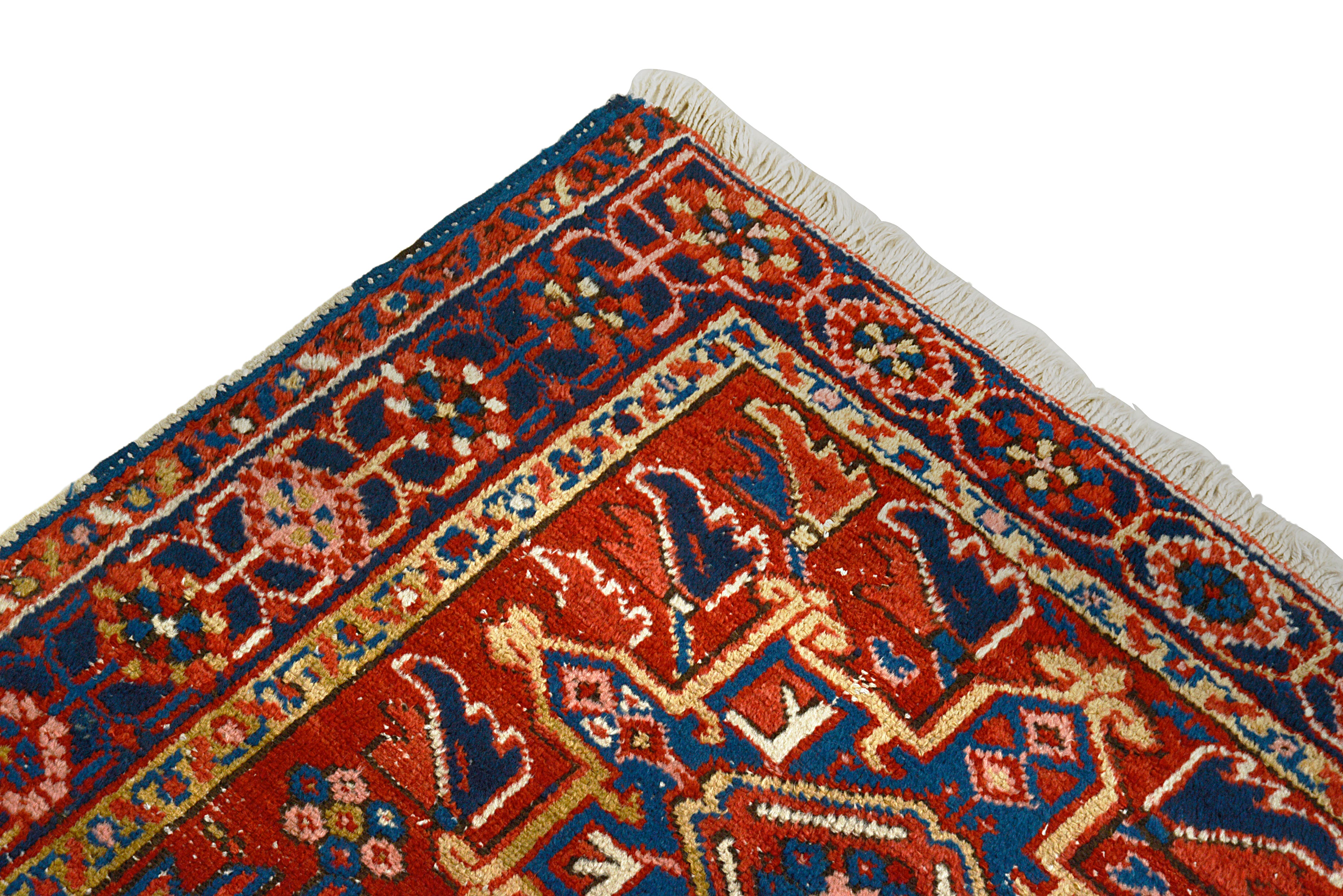 Close-up of a patterned Antique Persian Heriz rug corner with intricate designs.