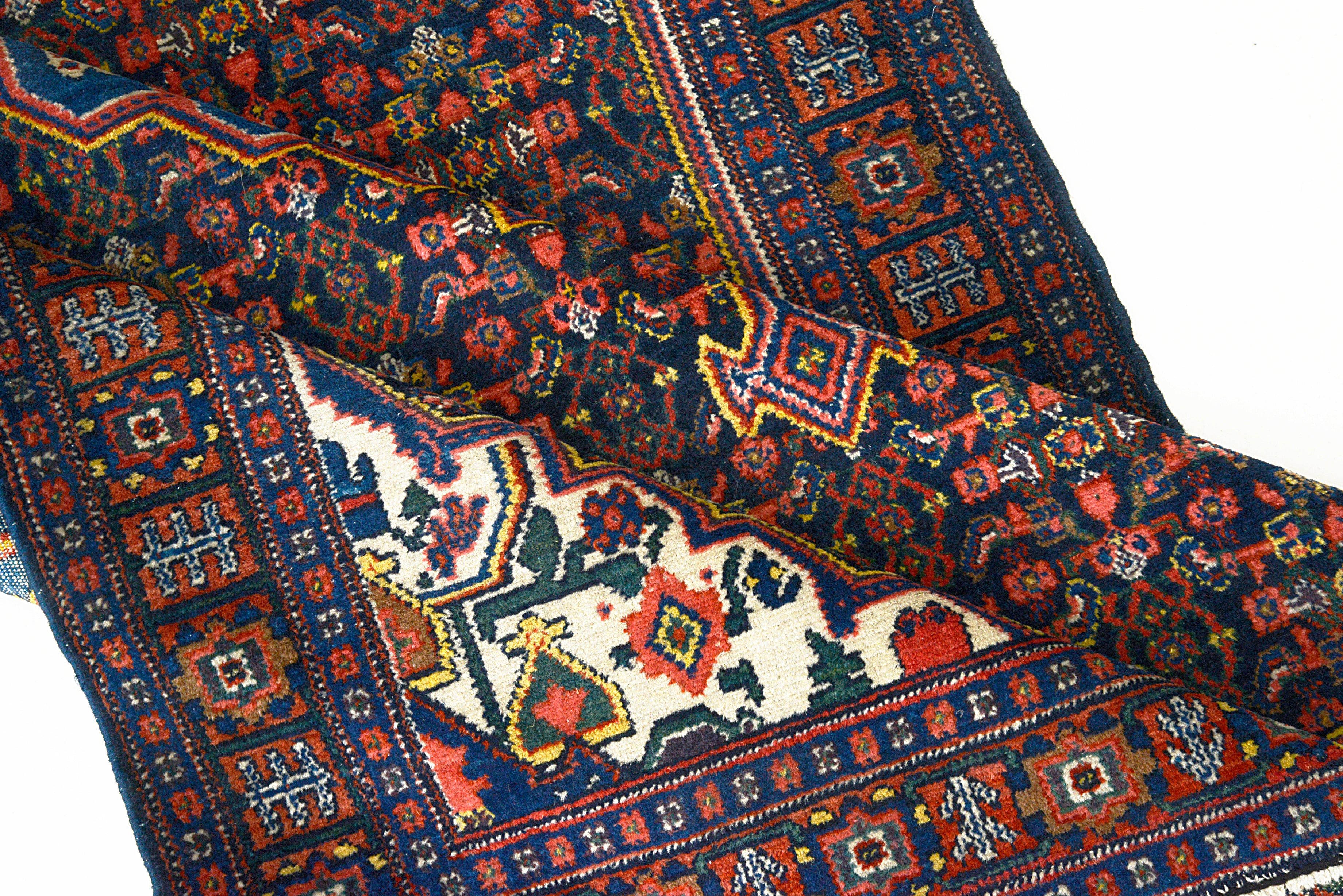 Fine hand-knotted wool texture of an antique Persian Senneh rug