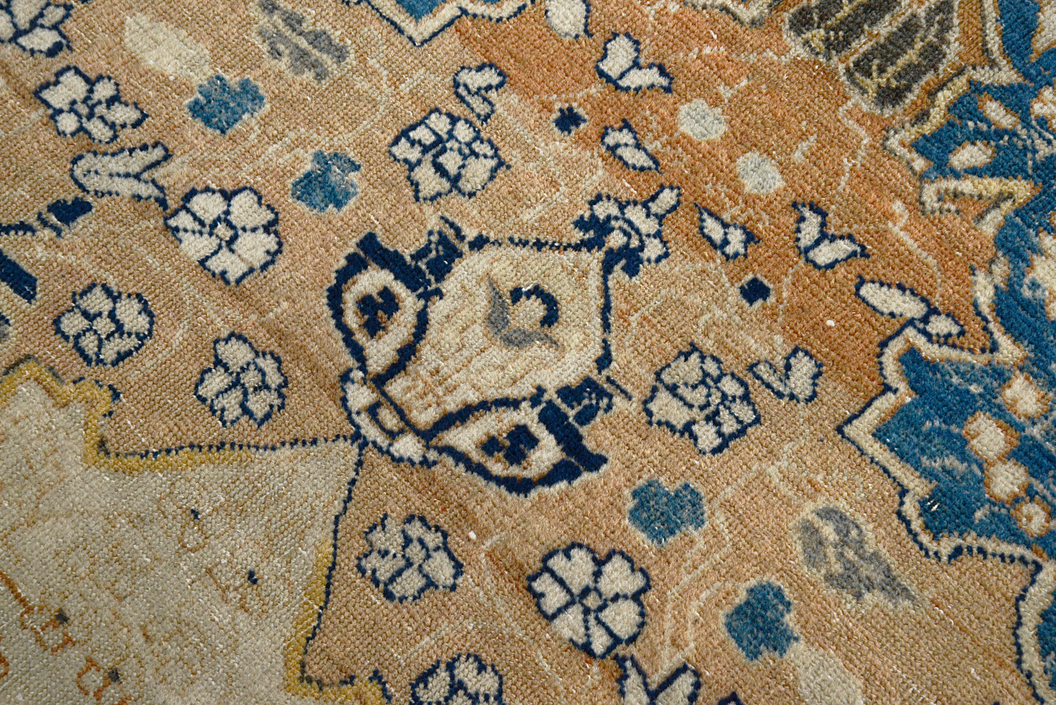 Hand-knotted wool texture of an antique Persian Tabriz rug
