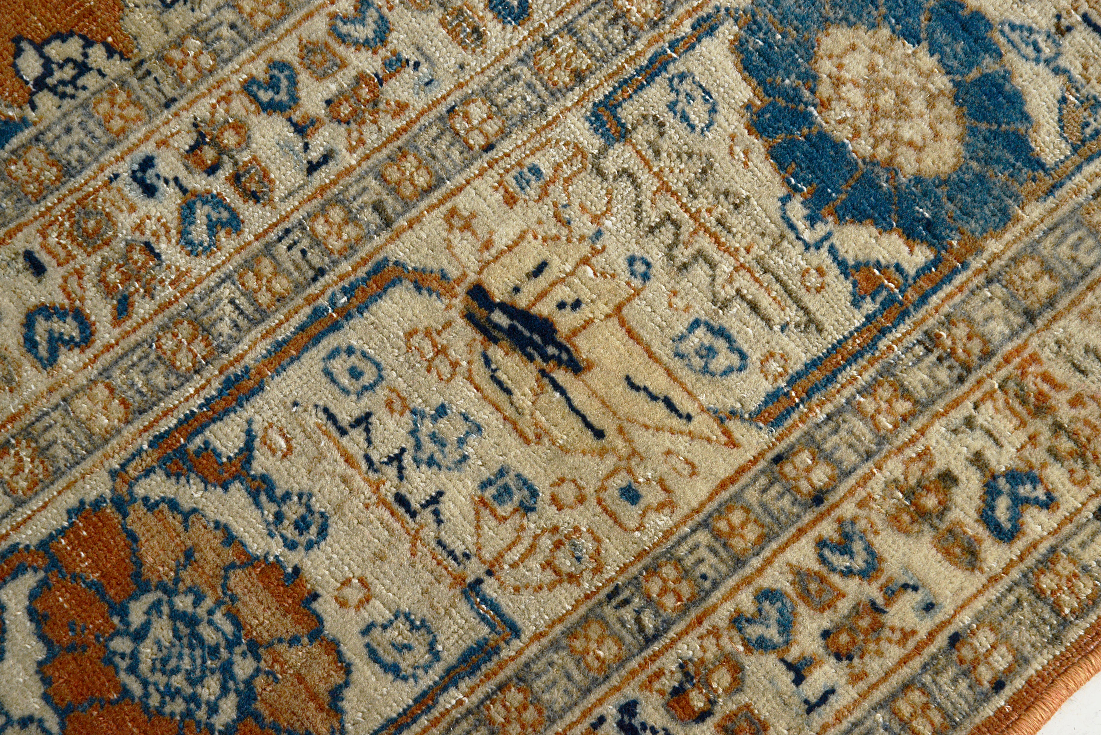 Close-up of an intricately patterned Tabriz rug with floral designs.