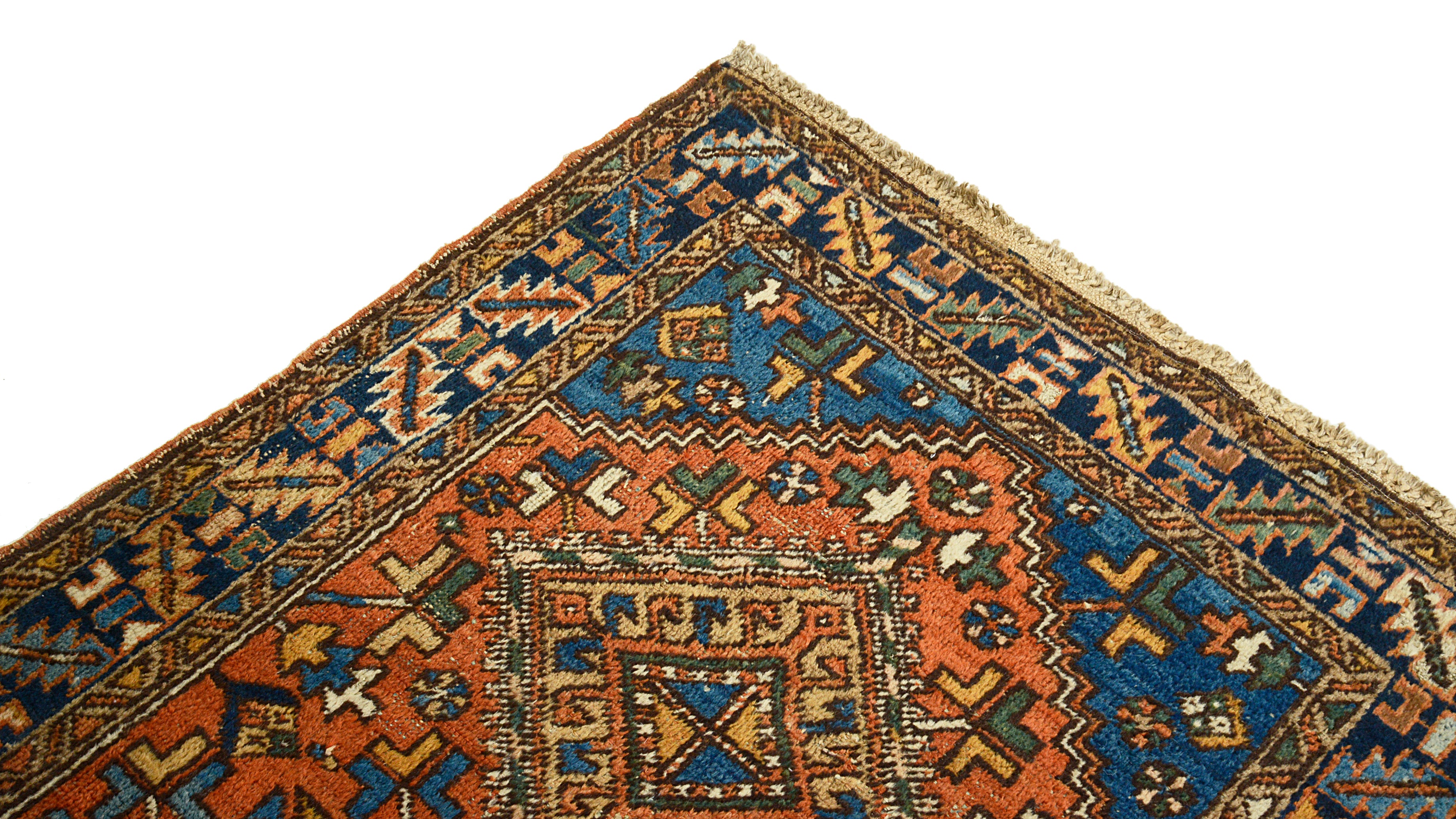 Close-up of a patterned Heriz rug corner with intricate designs.