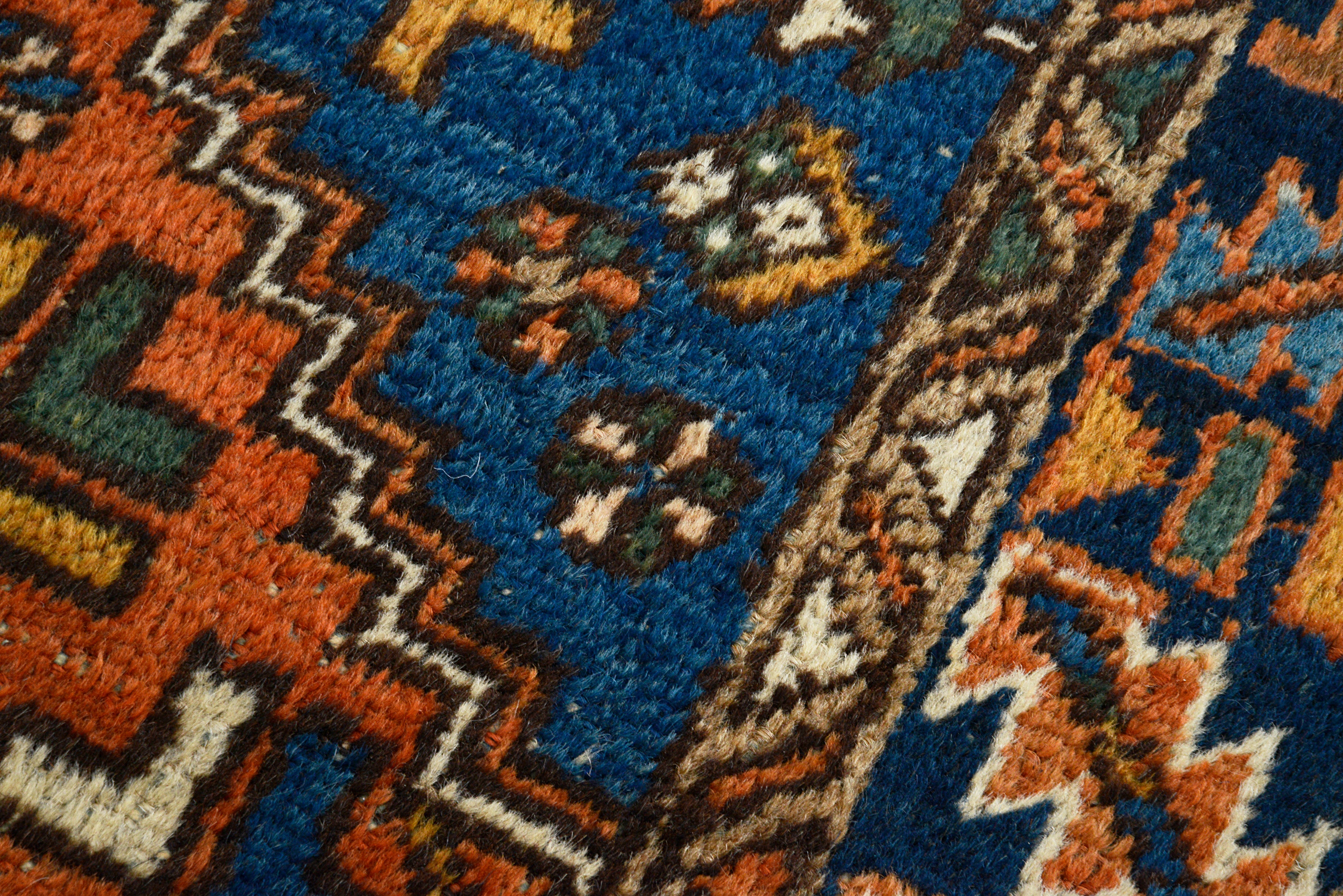 Hand-knotted wool texture of an antique Persian Heriz rug