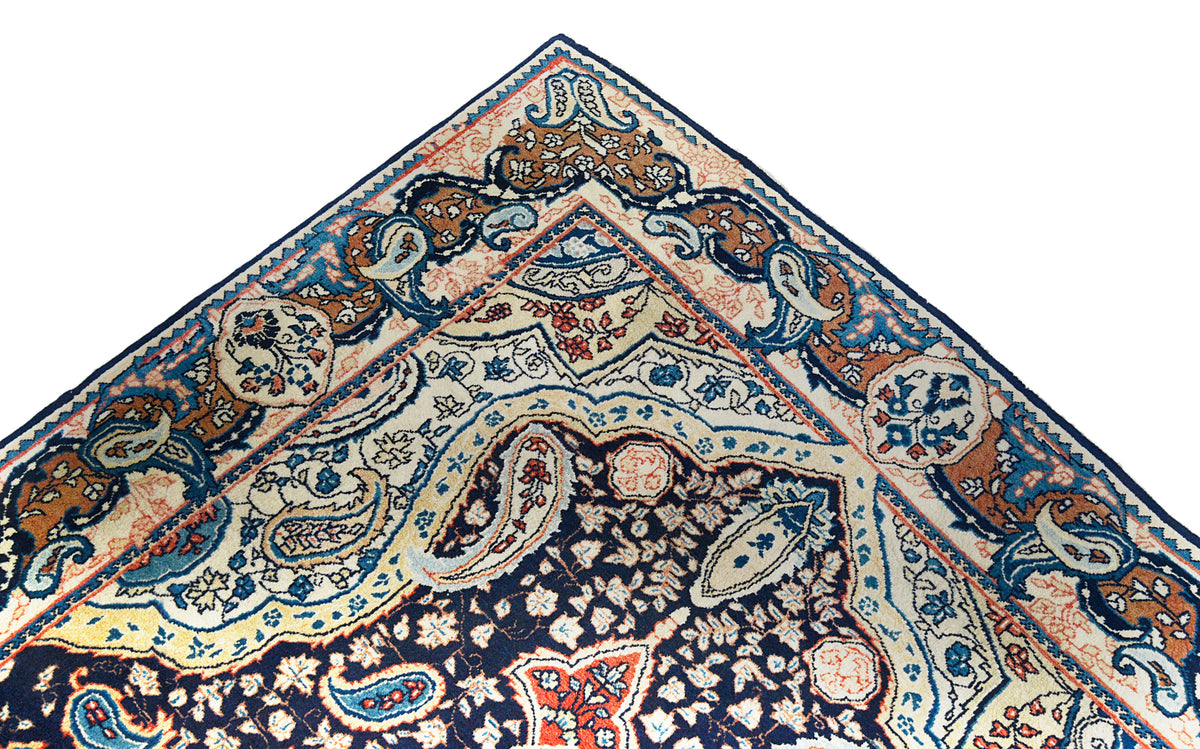 Close-up of Sarouk rug corner with intricate floral patterns and decorative border