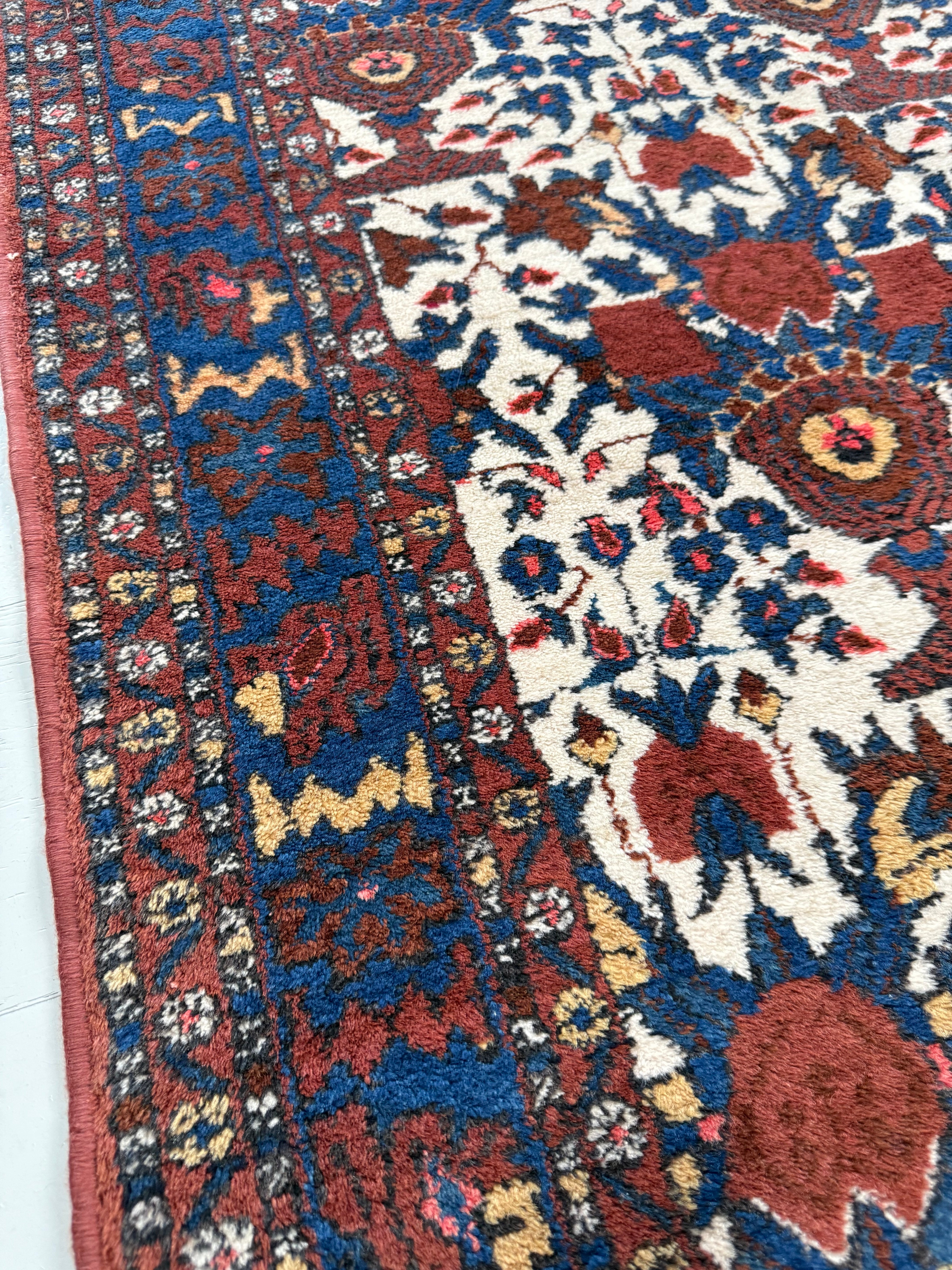 Close-up showing rich colours and tribal drawing of the border on antique Persian Afshar rug