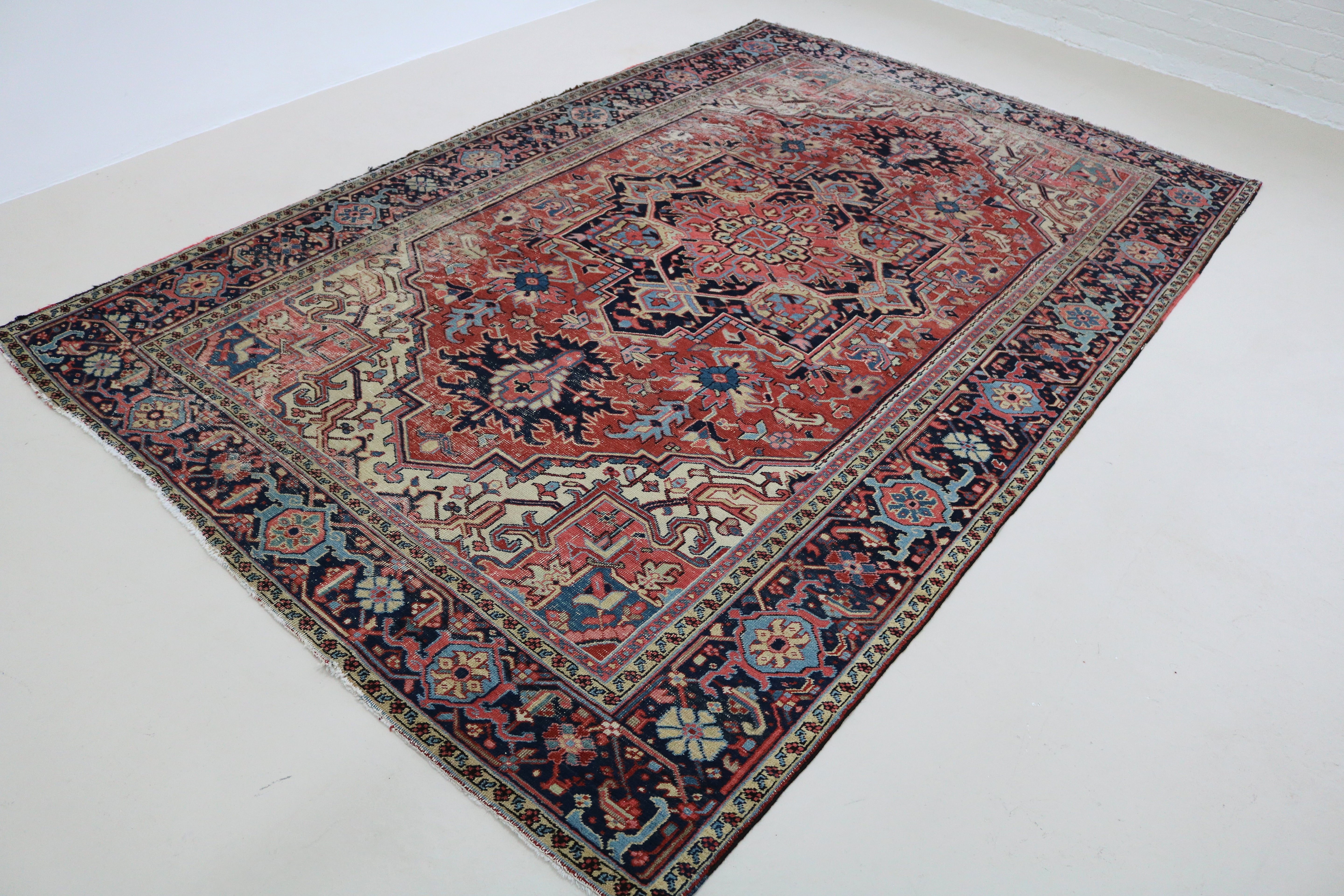 Angled view of fine antique Persian Heriz carpet highlighting overall pattern and composition