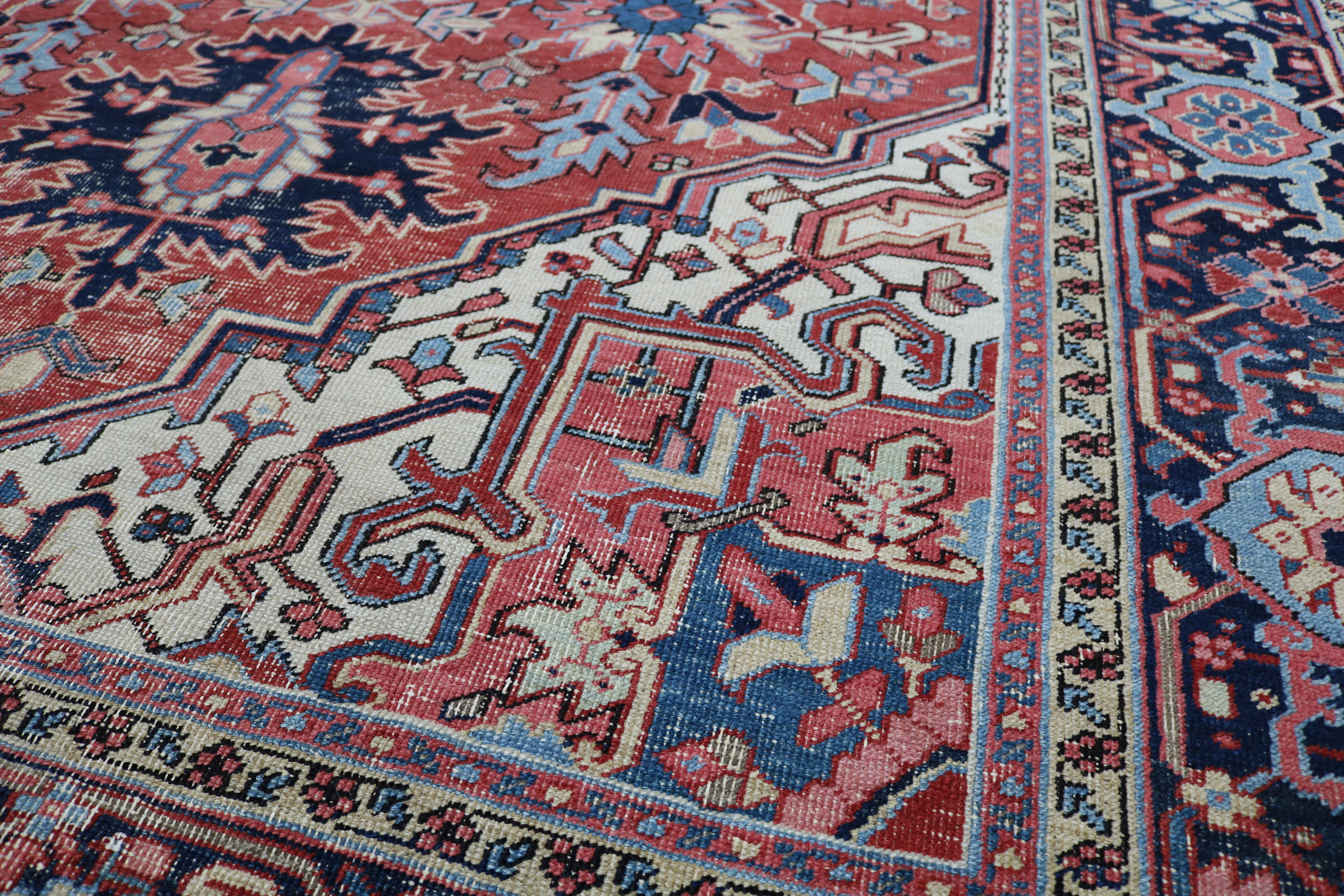 Close-up of hand-knotted wool texture on fine antique Persian Heriz carpet
